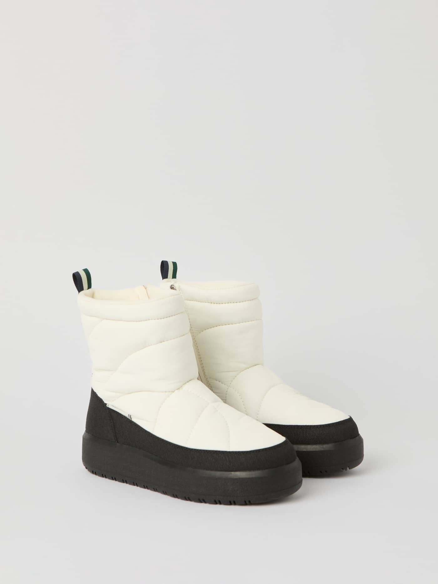 Side view of Women's Alpine Boots in White, featuring a quilted puffer design and black soles for a stylish fit. - Image 2