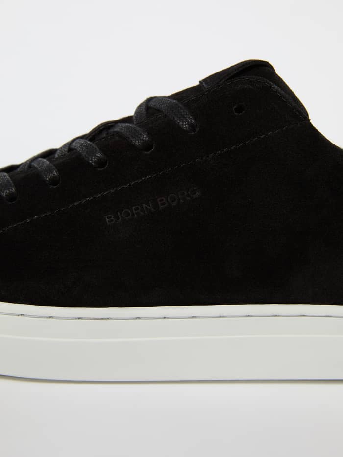 Close-up of black Men's Classic Suede Sneakers with a white sole and black logo for a stylish and functional tennis fit. - Image 4