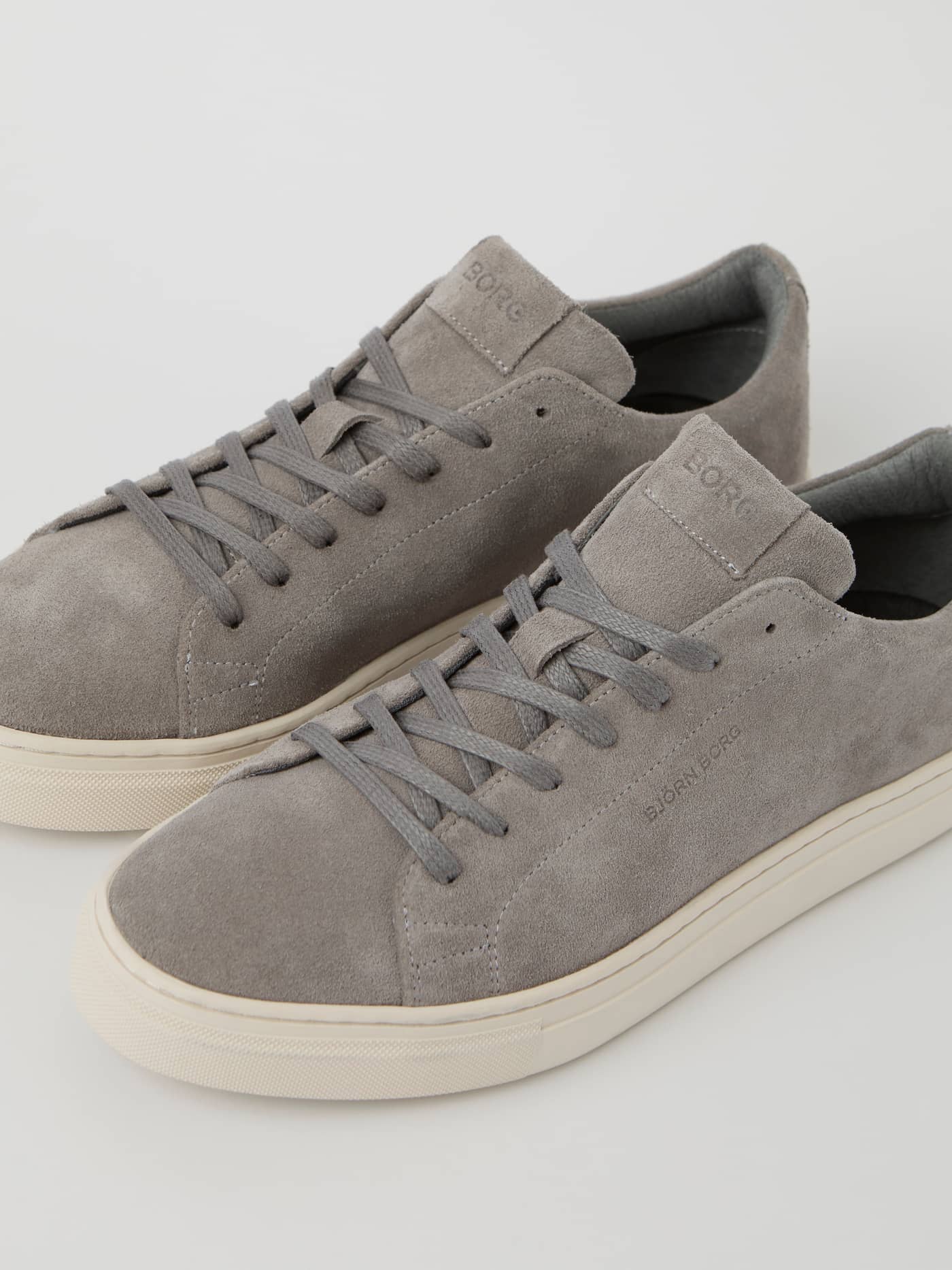 Angled view of the Men's Classic Suede Sneakers in Grey, with tonal logos and a tennis-inspired design for style and fit. - Image 3