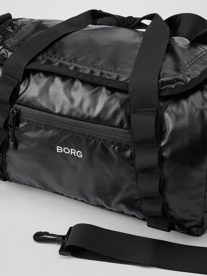 Detailed close-up of the glossy Black Beauty (Black) Borg Glossy Ripstop Sports Bag 25L for training with a white logo. - Image 3