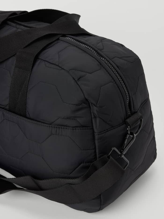 Close-up of the Borg Quilted Gym Bag in Black Beauty (Black) with a hexagonal quilted pattern and a durable chunky zipper. - Image 3