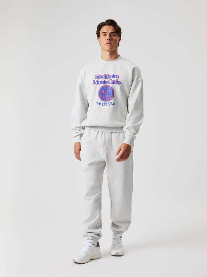 Vooraanzicht van een man in het Borg Oversized Sweatshirt in Ultra Light Grey Melange (Grijs) met een tennisgraphic. - Image 5
