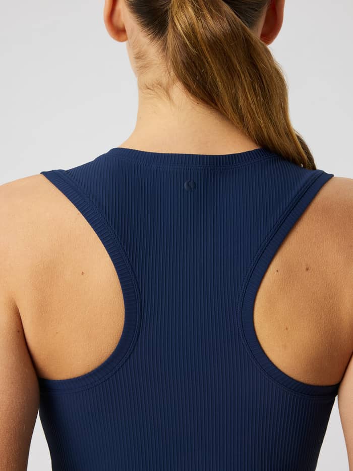 Back view of the Studio Ribbed Cropped Tank Top in Dress Blues, showcasing the racerback design and ribbed texture.