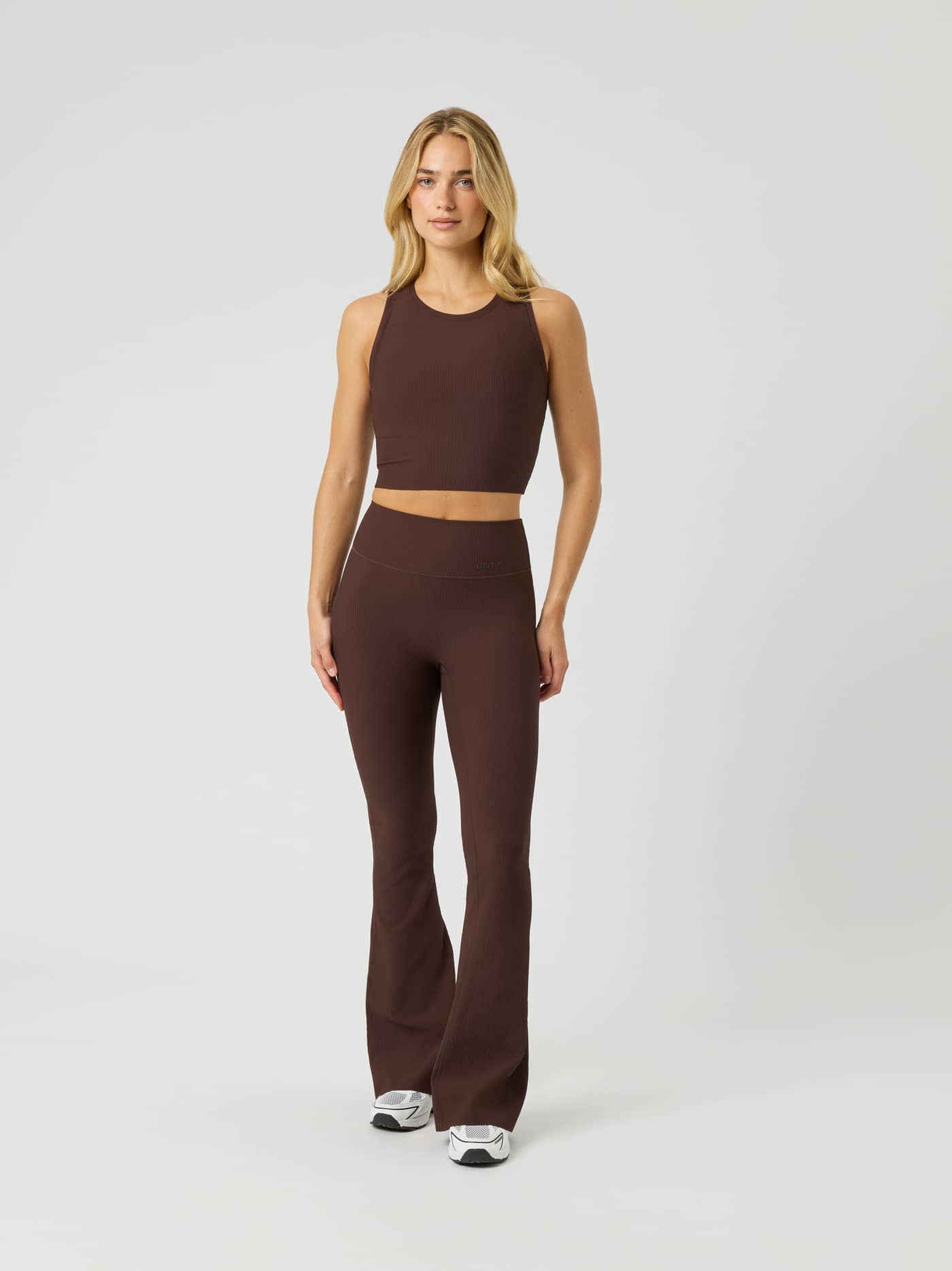 Full-body front view of a model wearing the Studio Ribbed Cropped Tank Top in Coffee Bean (Brown) for a training fit. - Image 5