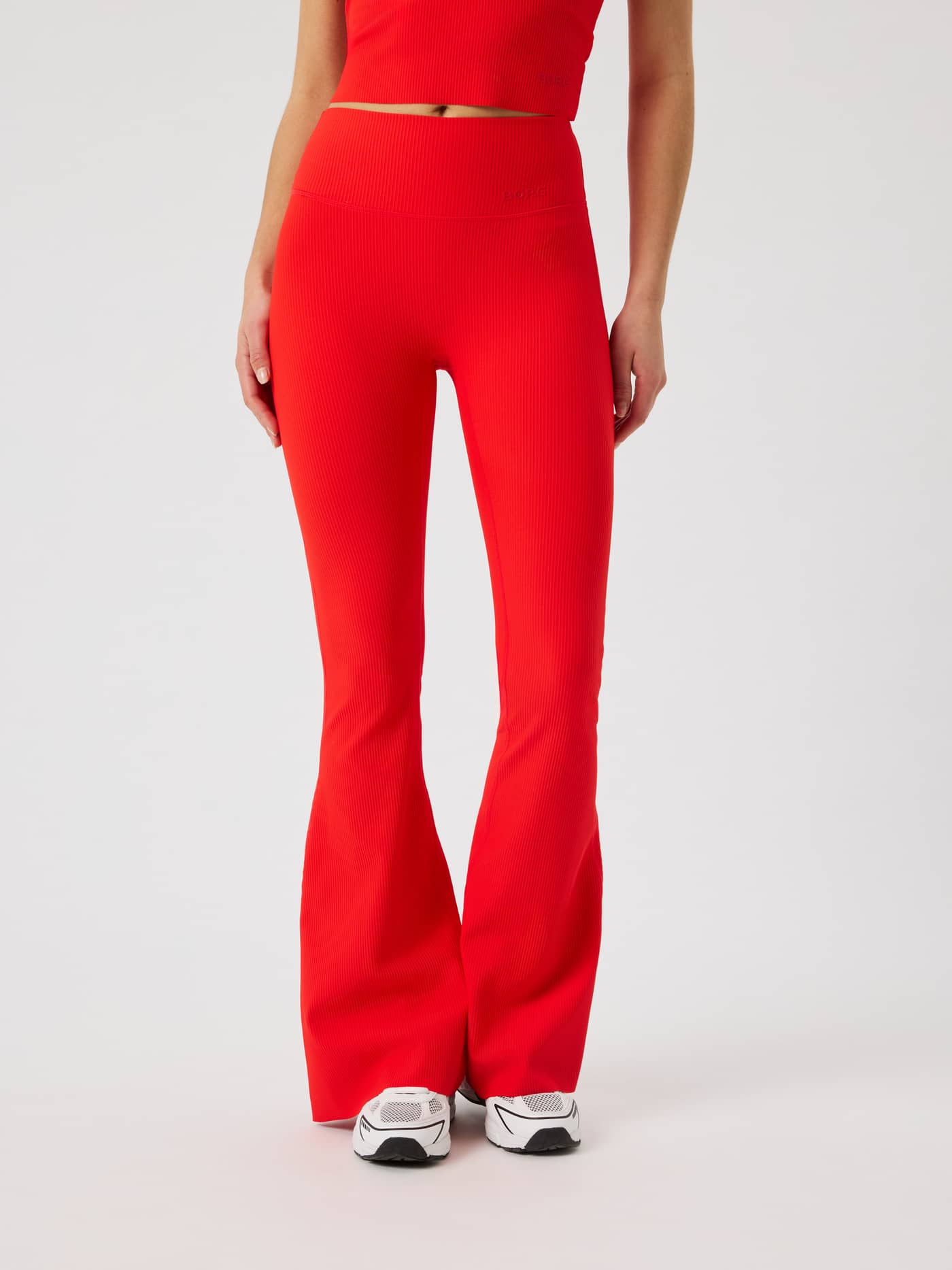 Front view of Studio Ribbed Flare Tights Regular in Flame Scarlet (Red) with a ribbed texture and flared training fit. - Image 2