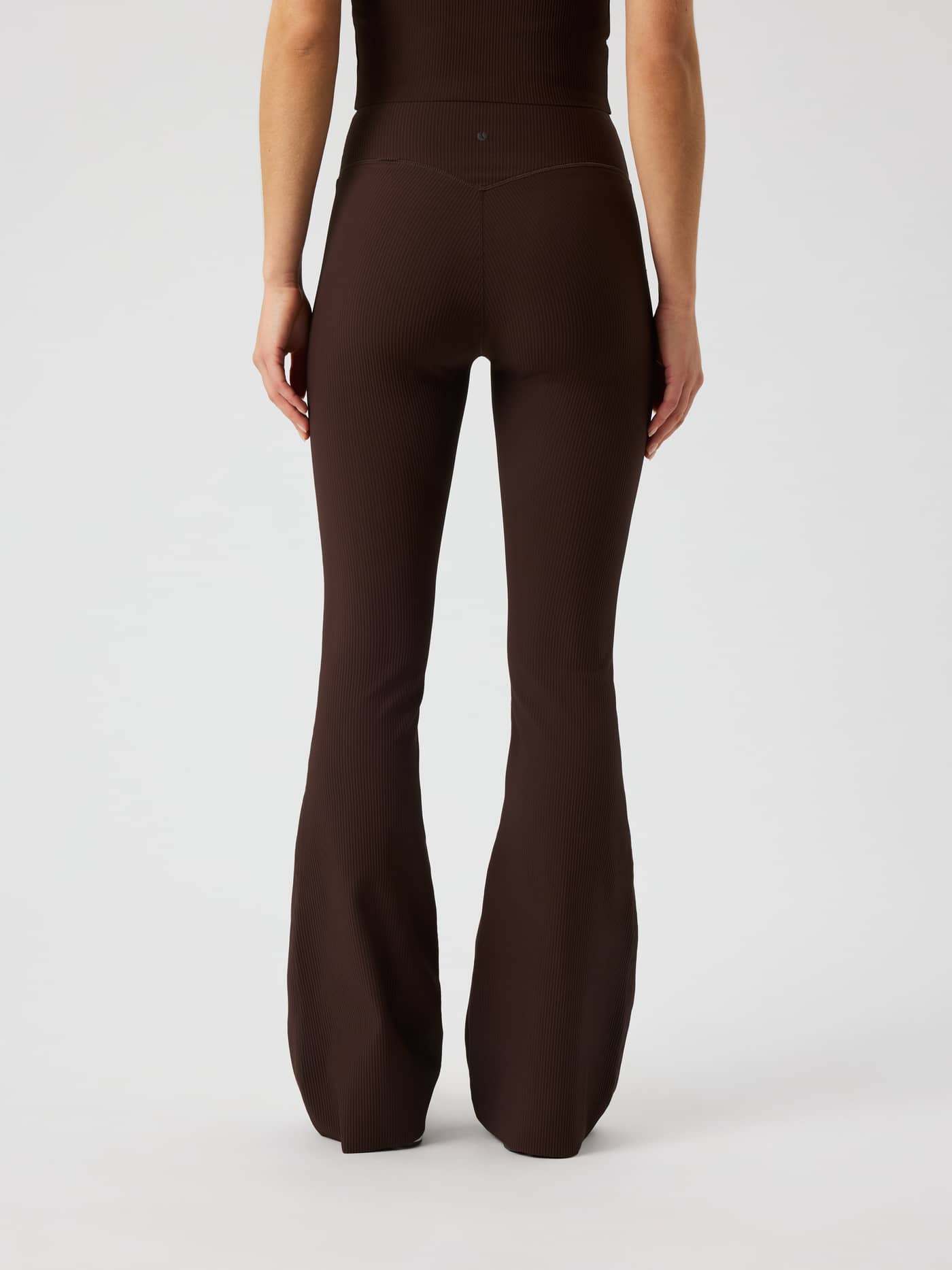 Back view of Studio Ribbed Flare Tights Regular in Coffee Bean (Brown) with ribbed fabric for training and tennis. - Image 3