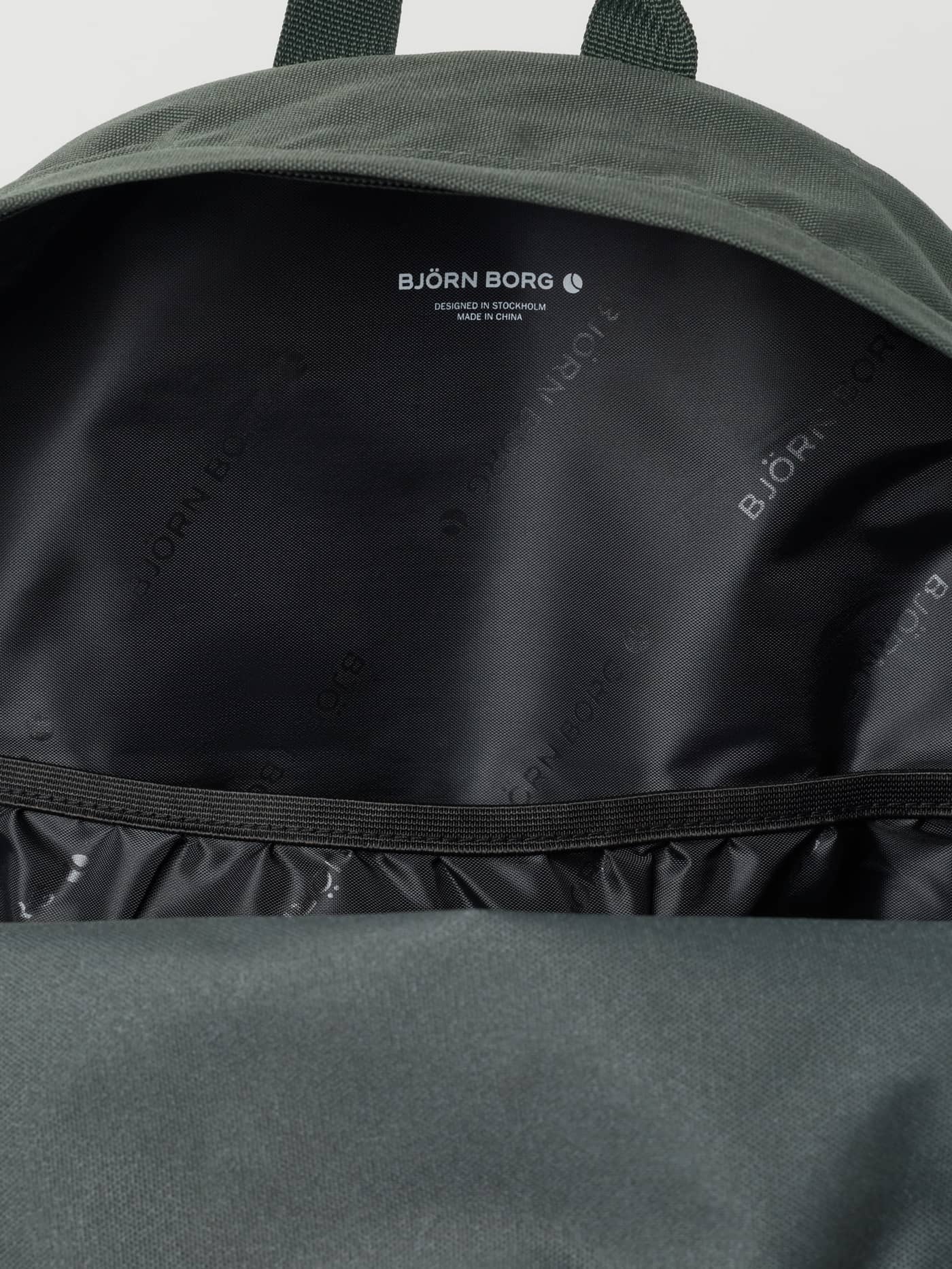 Inside view of the kids polyester Borg Junior Backpack 15L in Thyme (Green) with logo-print lining and white logo. - Image 3
