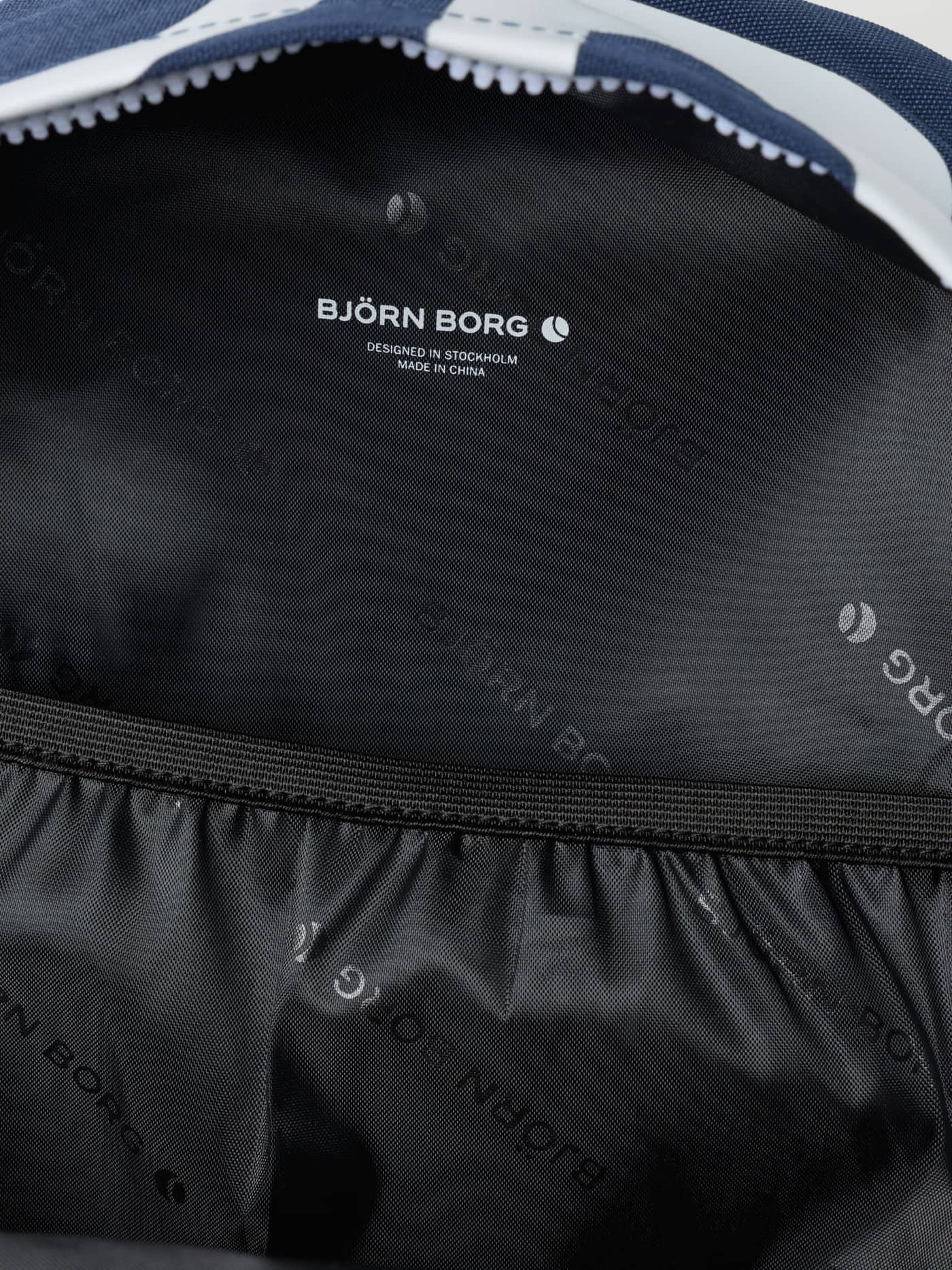 Interior view of the Estate Blue (Blue) Borg Logo Backpack 20L, showcasing the branded lining and training functionality. - Image 3