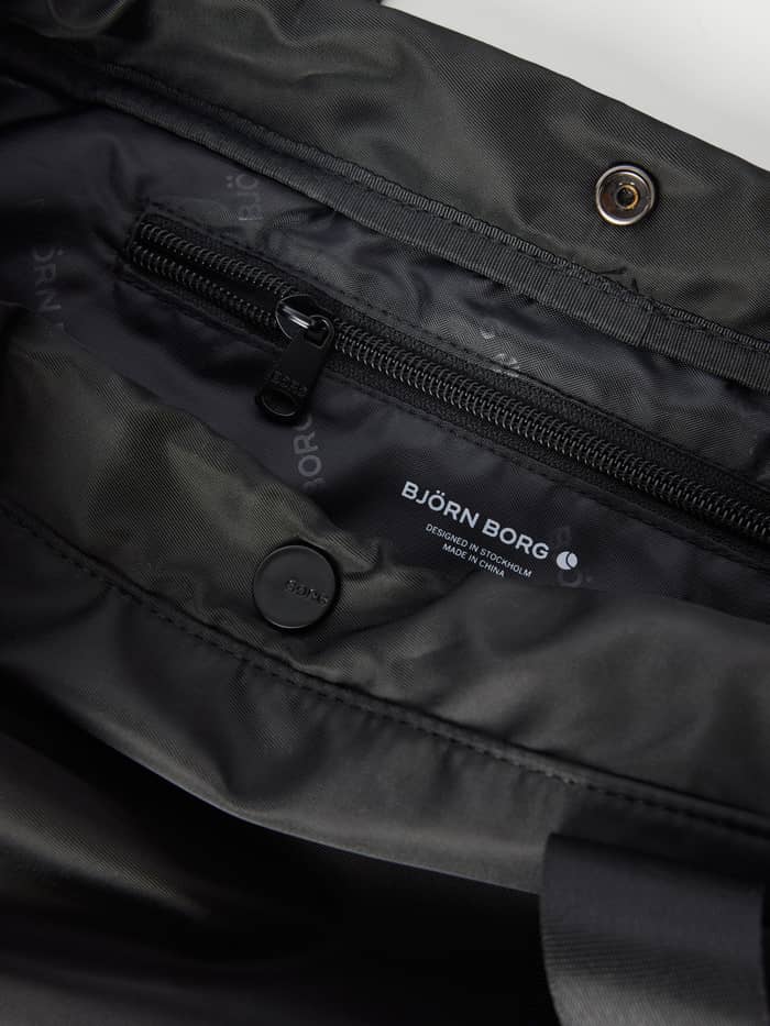 Borg Active Tote 19L in Black Beauty (Black) interior view, showing a zip pocket and white logo for training. - Image 4