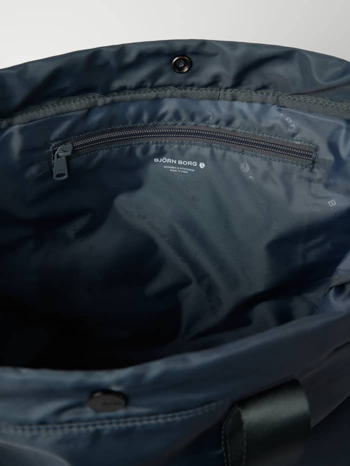 Detailed interior view of the Borg Active Tote 19L in Urban Chic (Navy), showing the zippered training pocket. - Image 3