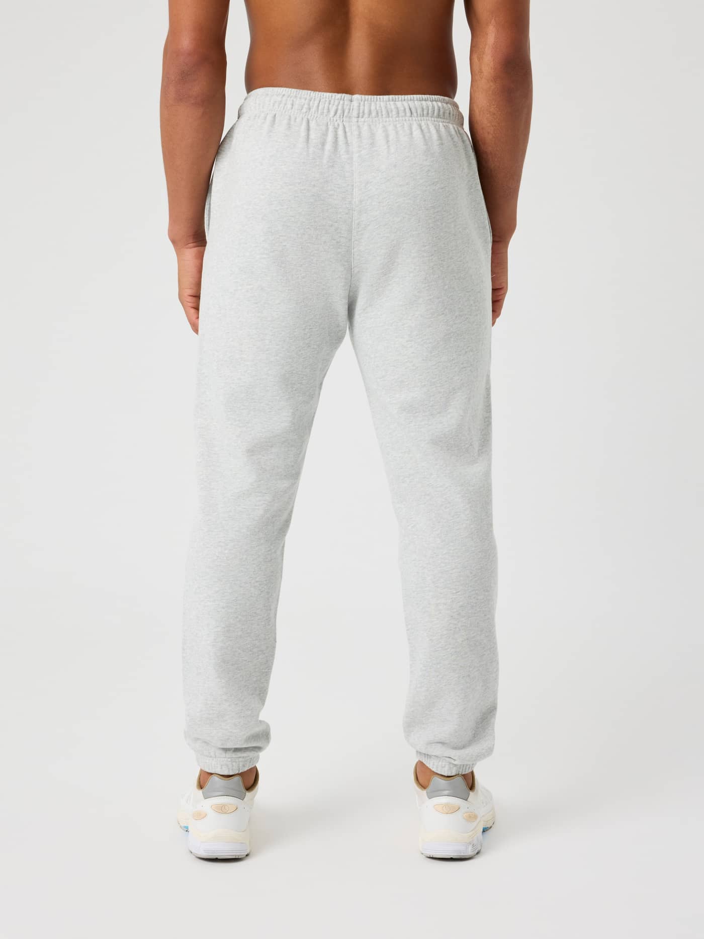 Back view of a man in cotton Björn Borg Classic Print Sweatpants in Ultra Light Grey Melange (Grey) with a regular fit. - Image 3