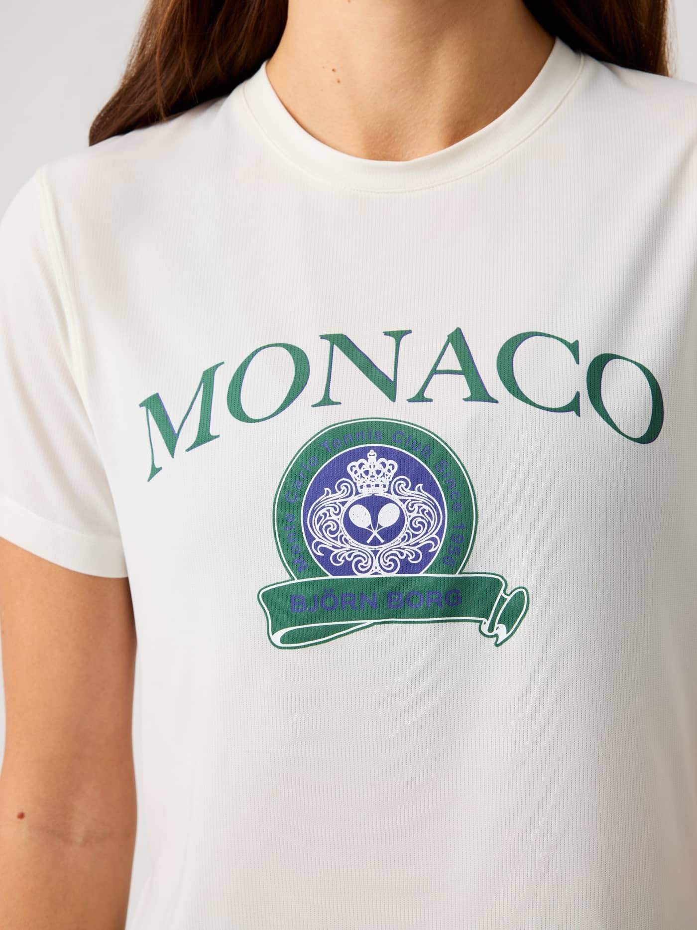 Close-up of the Borg Cropped T-Shirt in Tofu (White) featuring the green and purple Monaco tennis graphic for training. - Image 4
