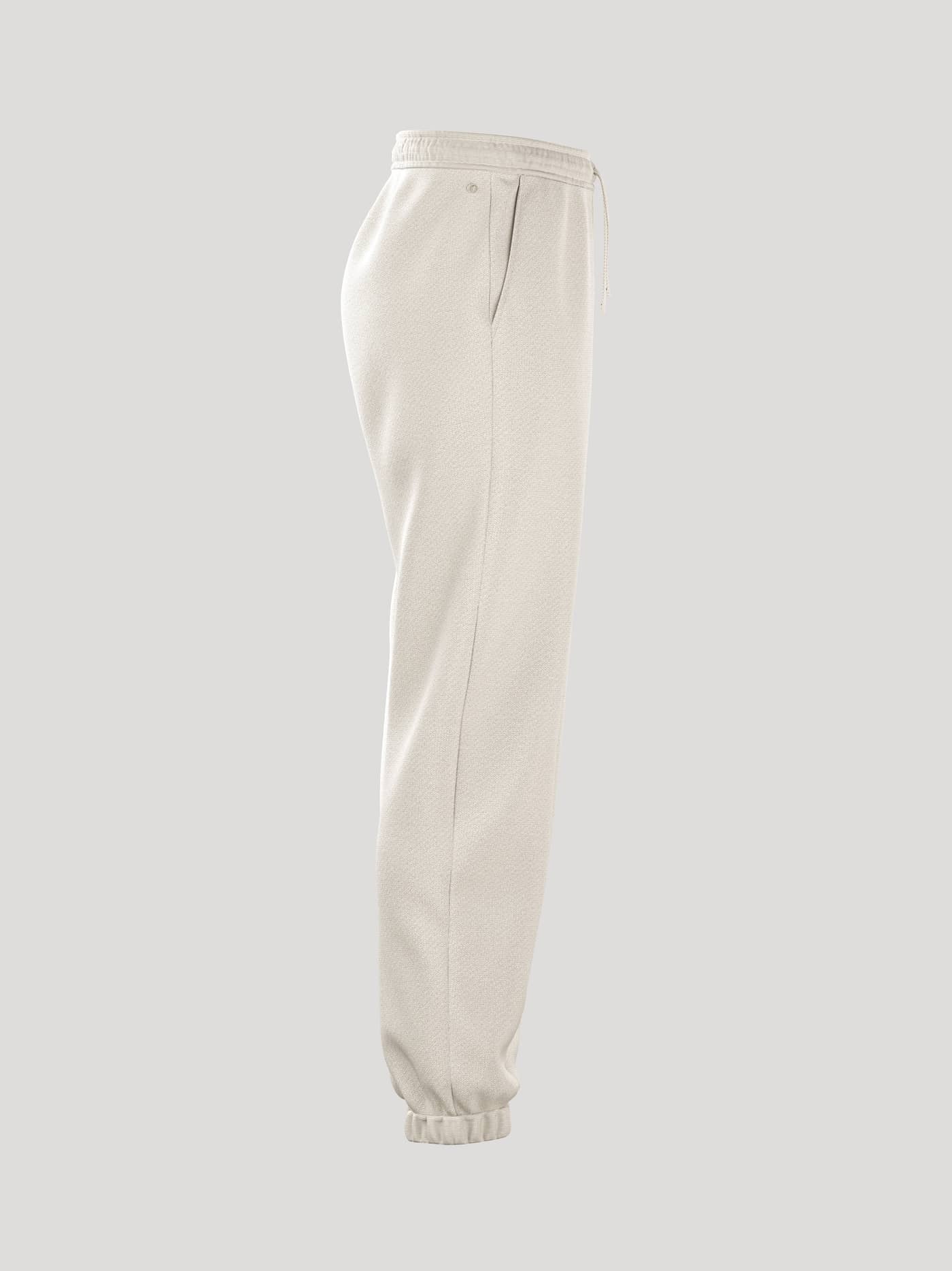 Side view of the Borg Essential 4 Sweatpants in Tofu (White) featuring a loose fit and ribbed cuffs. - Image 2