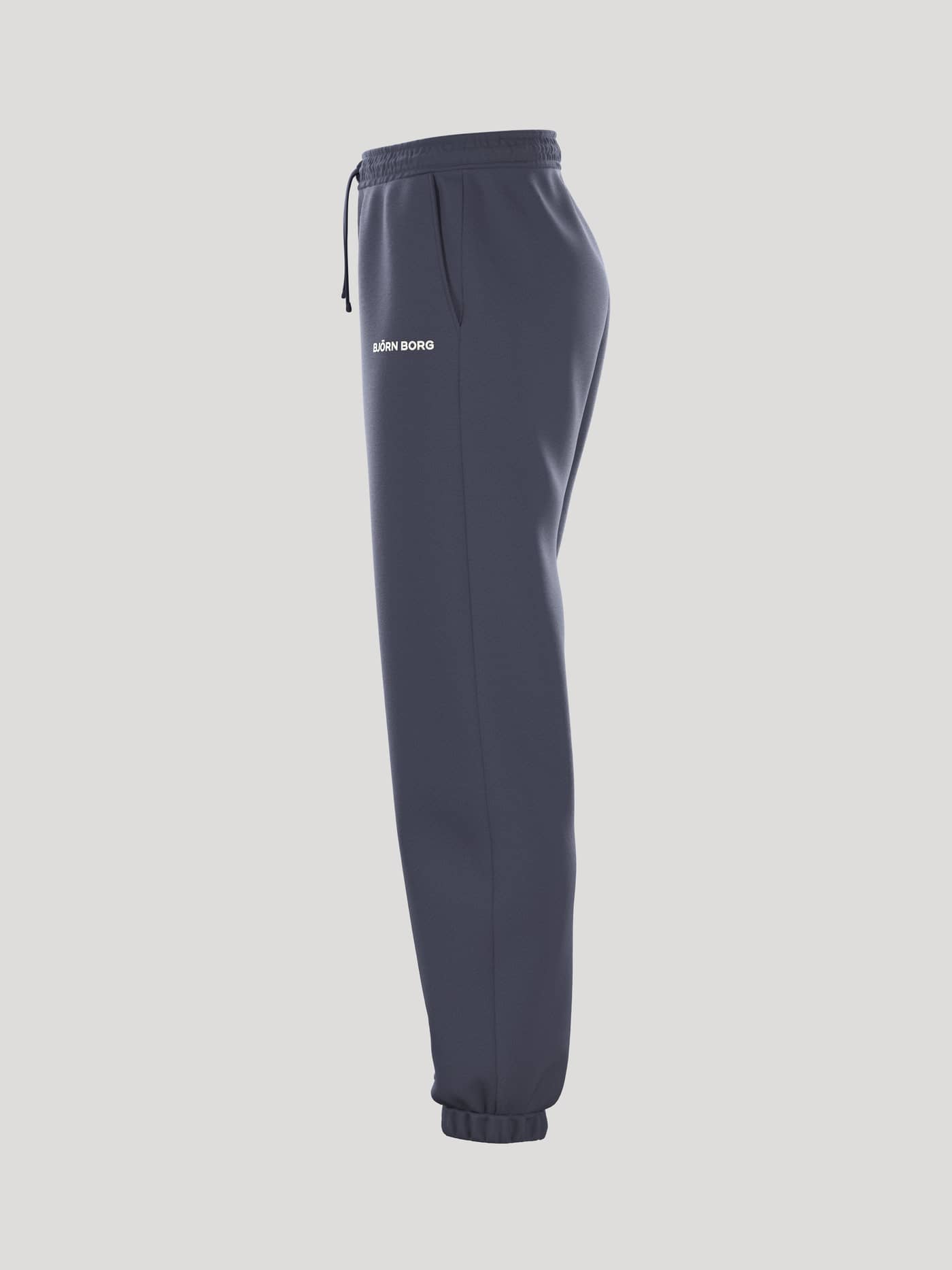 Side view of the loose-fit women's Borg Essential 4 Sweatpants in Odyssey Gray (Navy) in French terry with a white logo. - Image 4