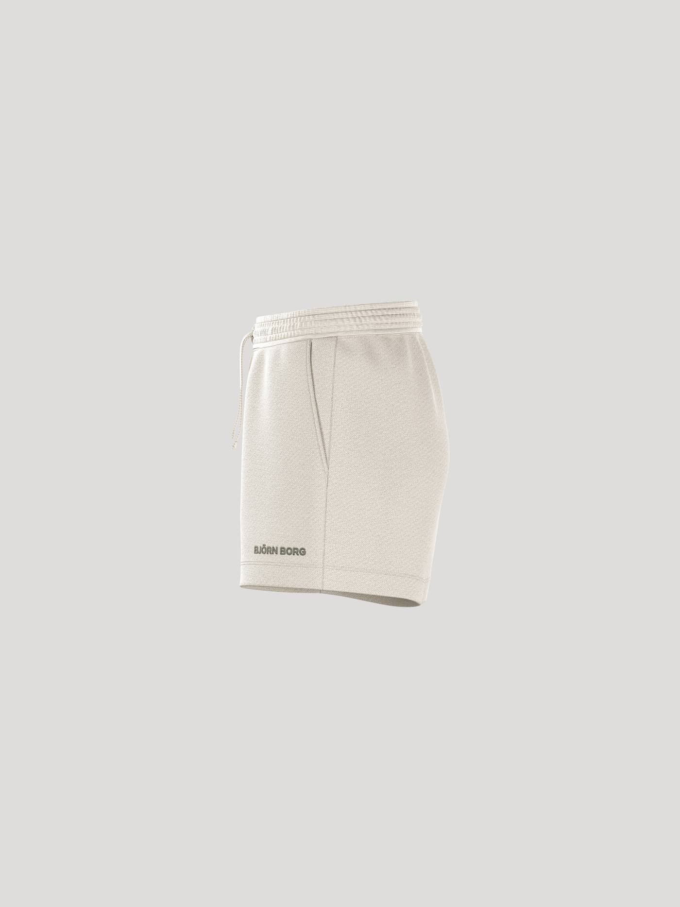 Zijaanzicht van de Borg Essential 4 Sweatshorts voor dames in Tofu (Wit) met een regular fit en zwart logo. - Image 4