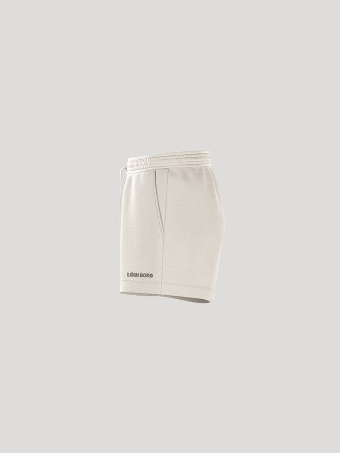 Side profile of women's Björn Borg Essential 4 Sweatshorts in Tofu (White), featuring a regular fit and a black logo. - Image 4