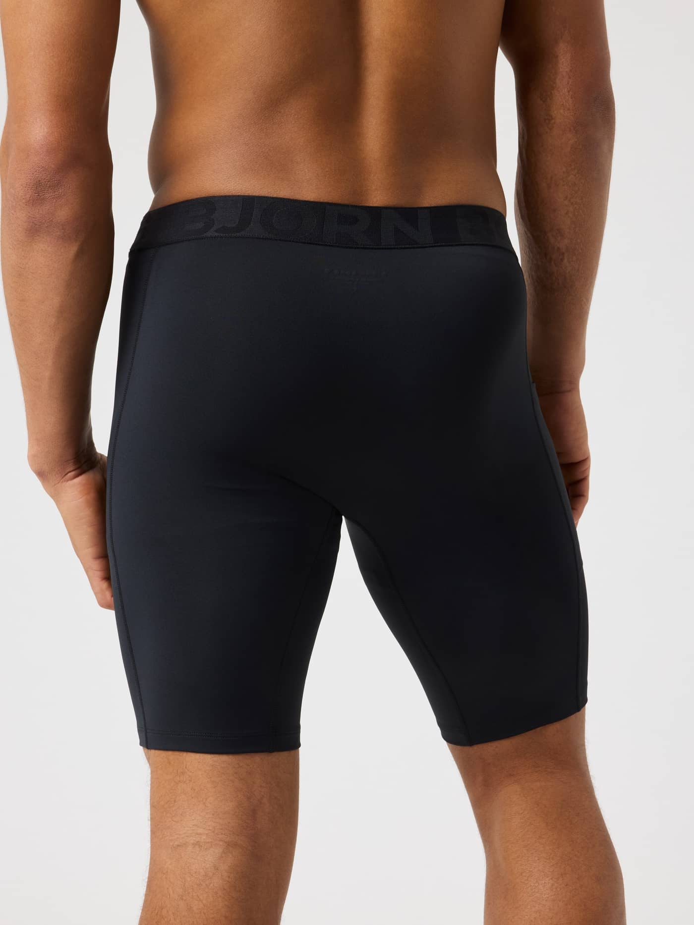 Back view of a man wearing the Borg Short Training Tights in Black Beauty (Black), featuring a supportive, athletic fit. - Image 2