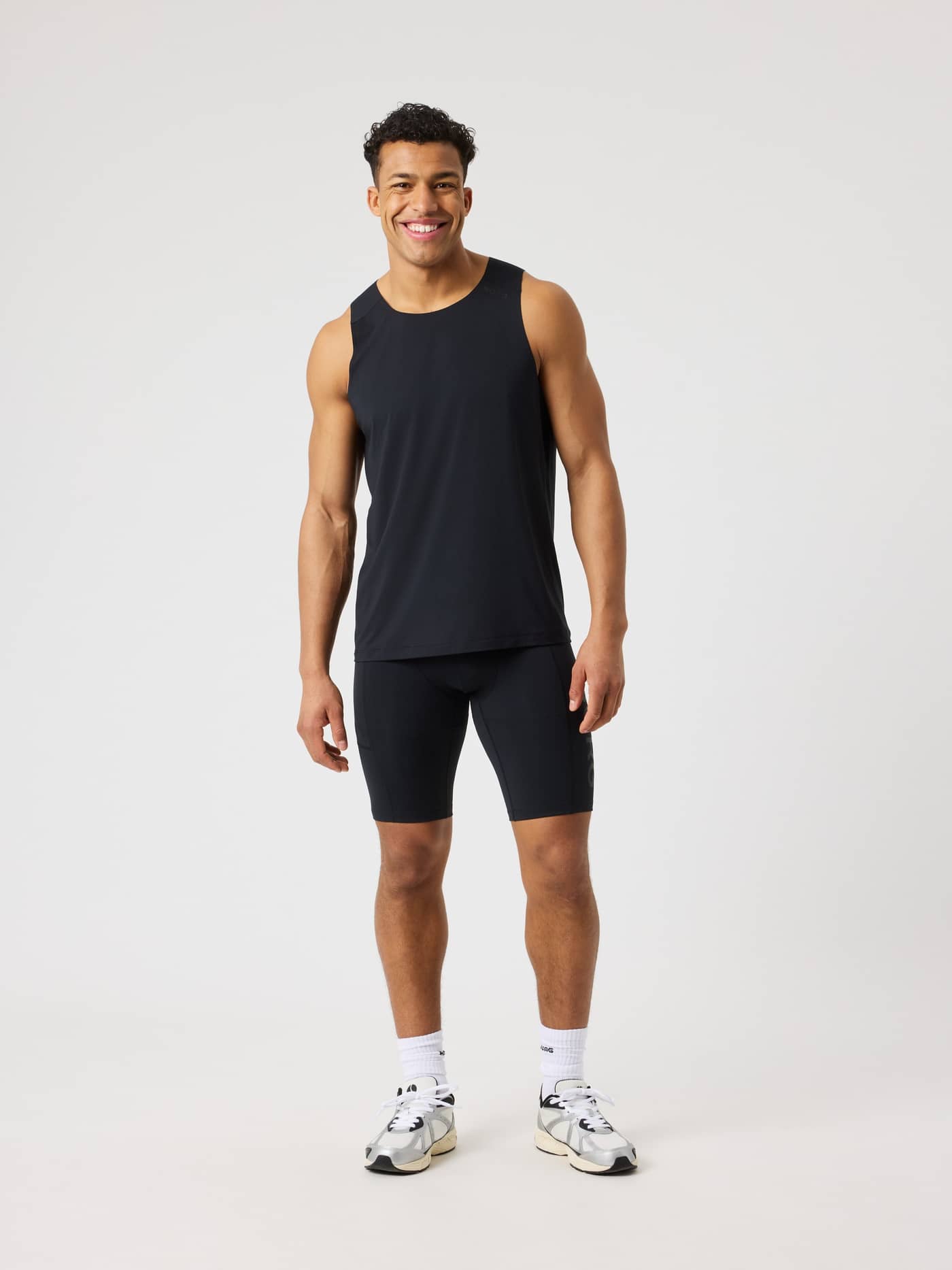 Full-body front view of a man wearing the slim Borg Short Training Tights in Black Beauty (Black) for training. - Image 3