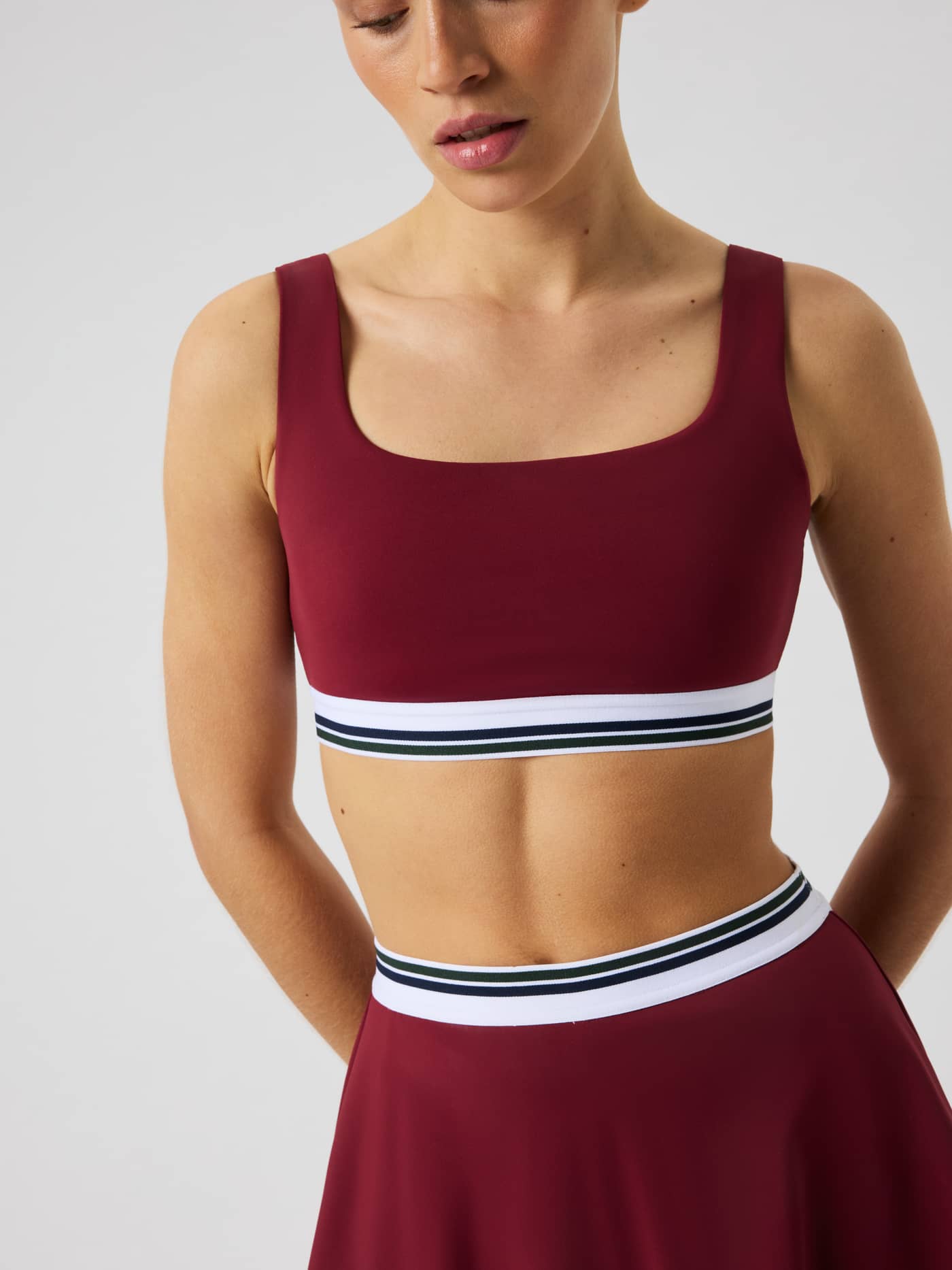 Close-up of the Ace Court Top in Cabernet (Burgundy) for tennis featuring an elastic waistband. - Image 5
