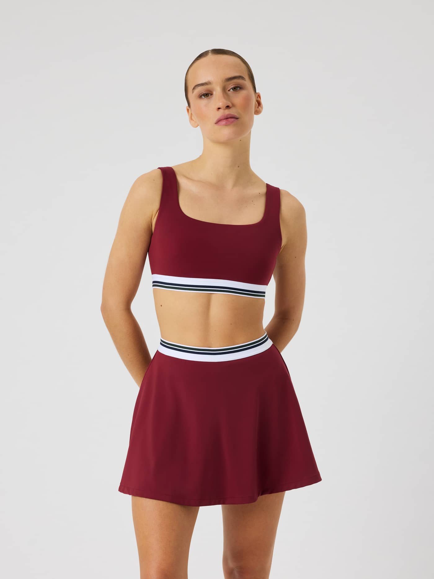 Front view of the Ace Court Top in Cabernet (Burgundy) for tennis and padel performance. - Image 1