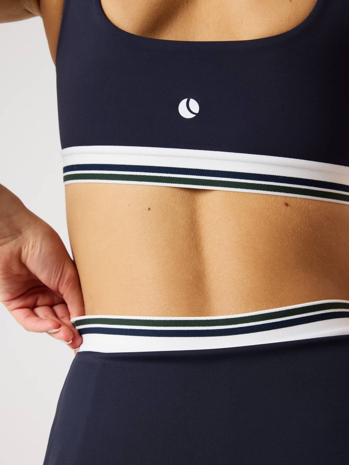 Back view of Björn Borg Ace Court Top in Night sky (Navy), with a white logo and striped waistband for a stylish tennis fit. - Image 4