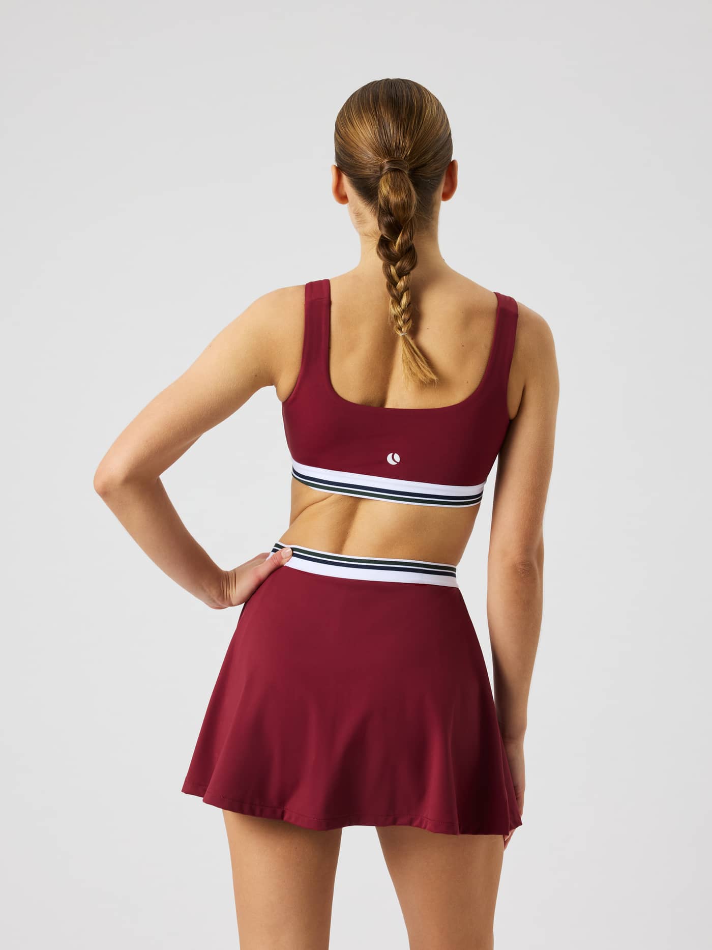 Back view of the Ace Court Top in Cabernet (Burgundy) for tennis and padel, featuring a white logo. - Image 3