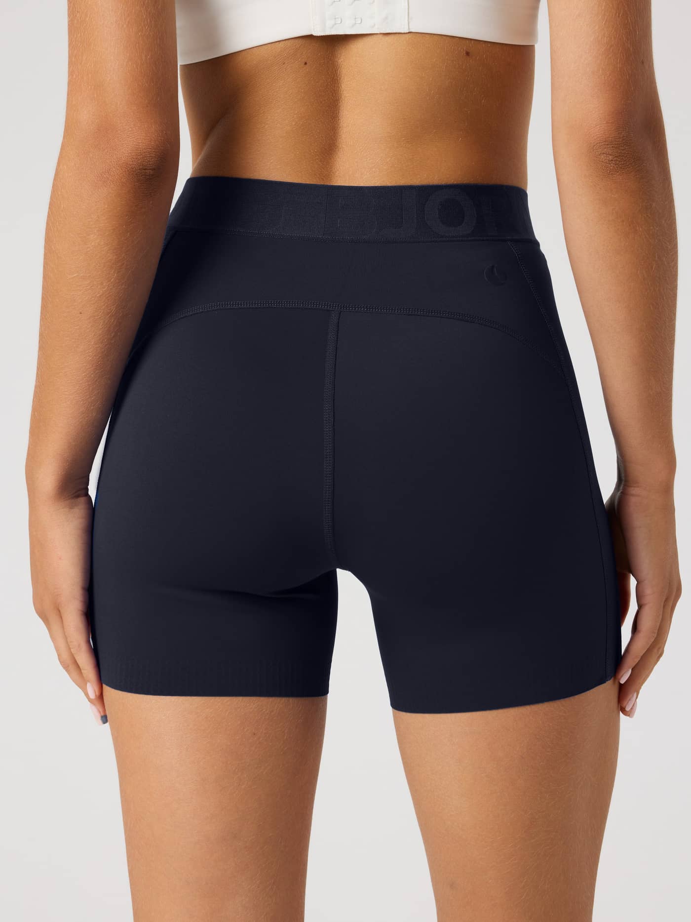 Back view of a model in Night sky (Navy) Borg Short Tights, featuring a supportive performance fit for tennis and training. - Image 2