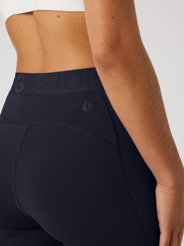 Side view of the Borg Short Tights in Night sky (Navy), showing the branded waistband and tonal logo for a training fit. - Image 3