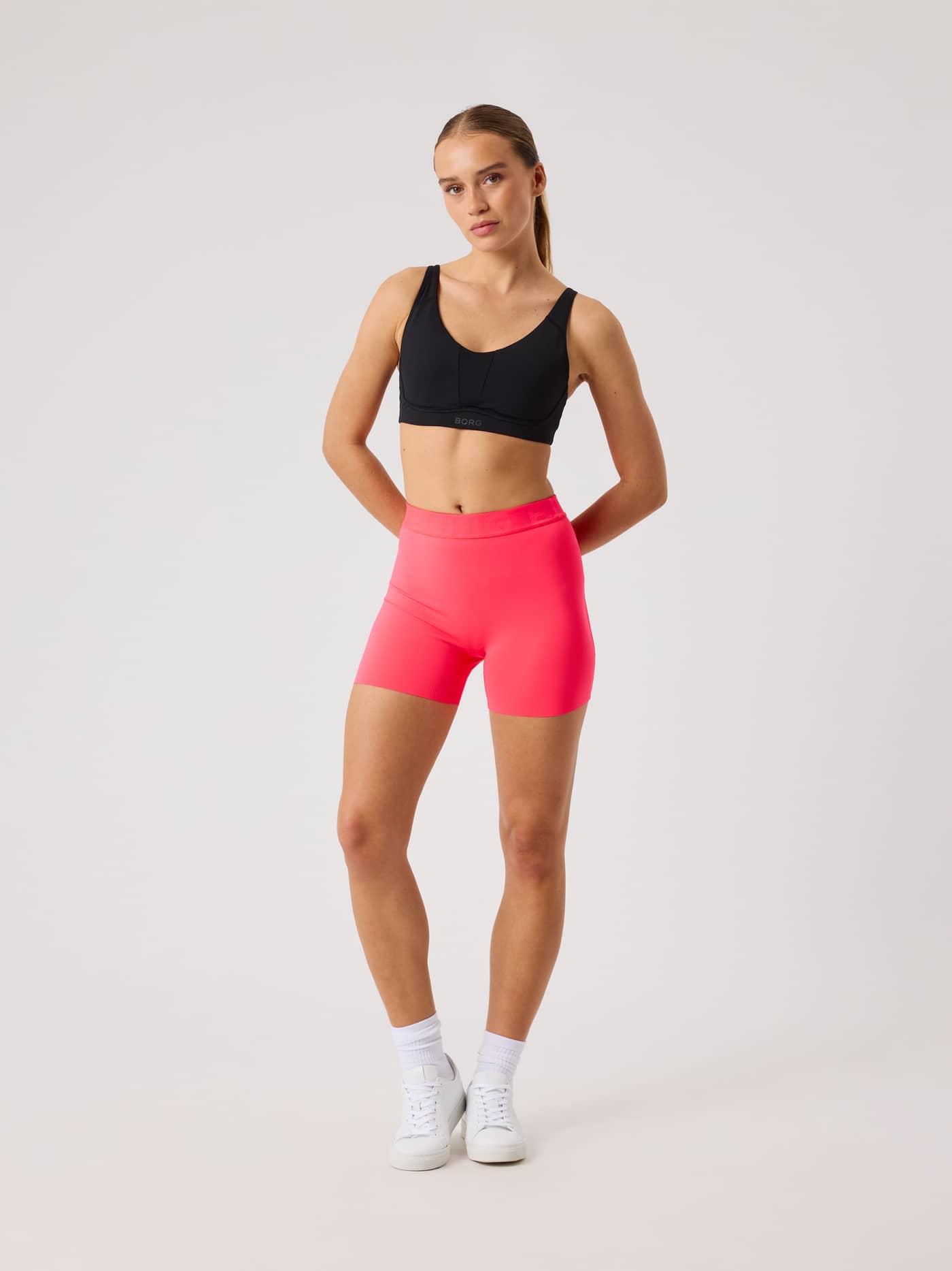 Front view of a model wearing Diva Pink (Pink) Borg Short Tights, offering an athletic fit for training and tennis. - Image 3