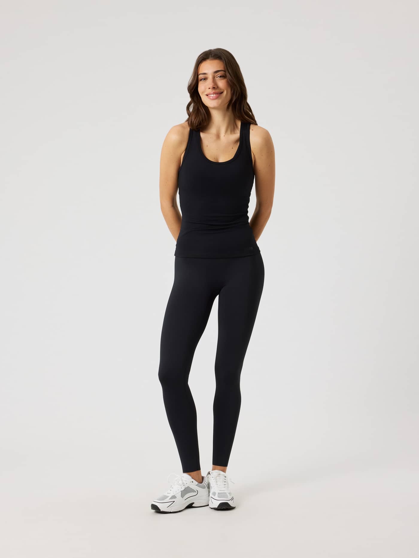 Full-body front view of a woman wearing the slim-fit training Borg Tights in Black Beauty (Black). - Image 3