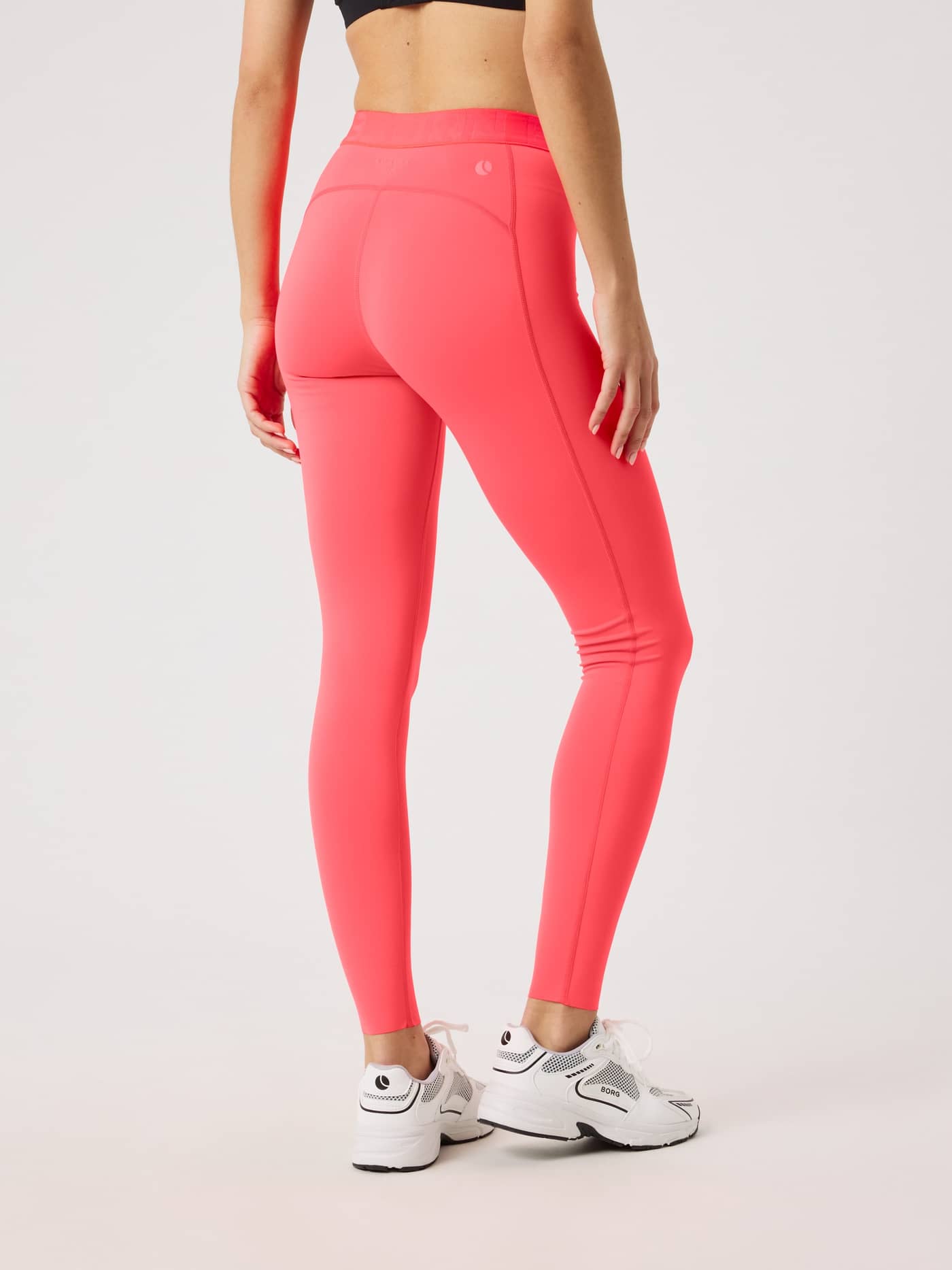 Back view of a model in Diva Pink (Pink) Borg Tights, stylish women's training tights with a slim fit and white logo. - Image 2