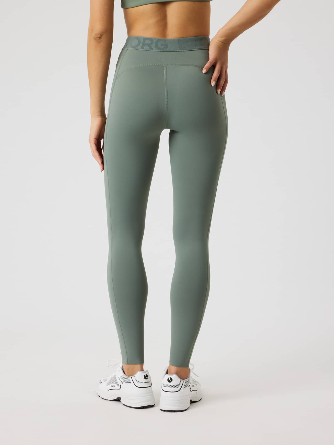 Back view of a model in Agave Green (Green) Borg Tights by Björn Borg, with a tonal logo and slim training fit. - Image 3