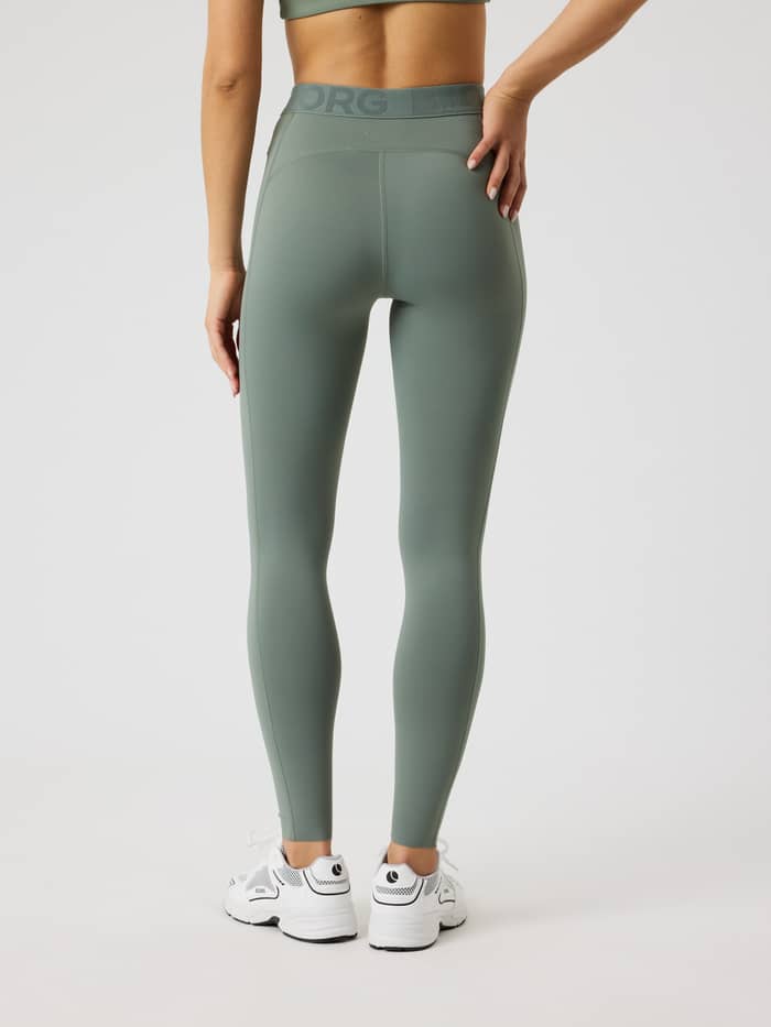 Back view of a model in Agave Green (Green) Borg Tights by Björn Borg, with a tonal logo and slim training fit. - Image 3
