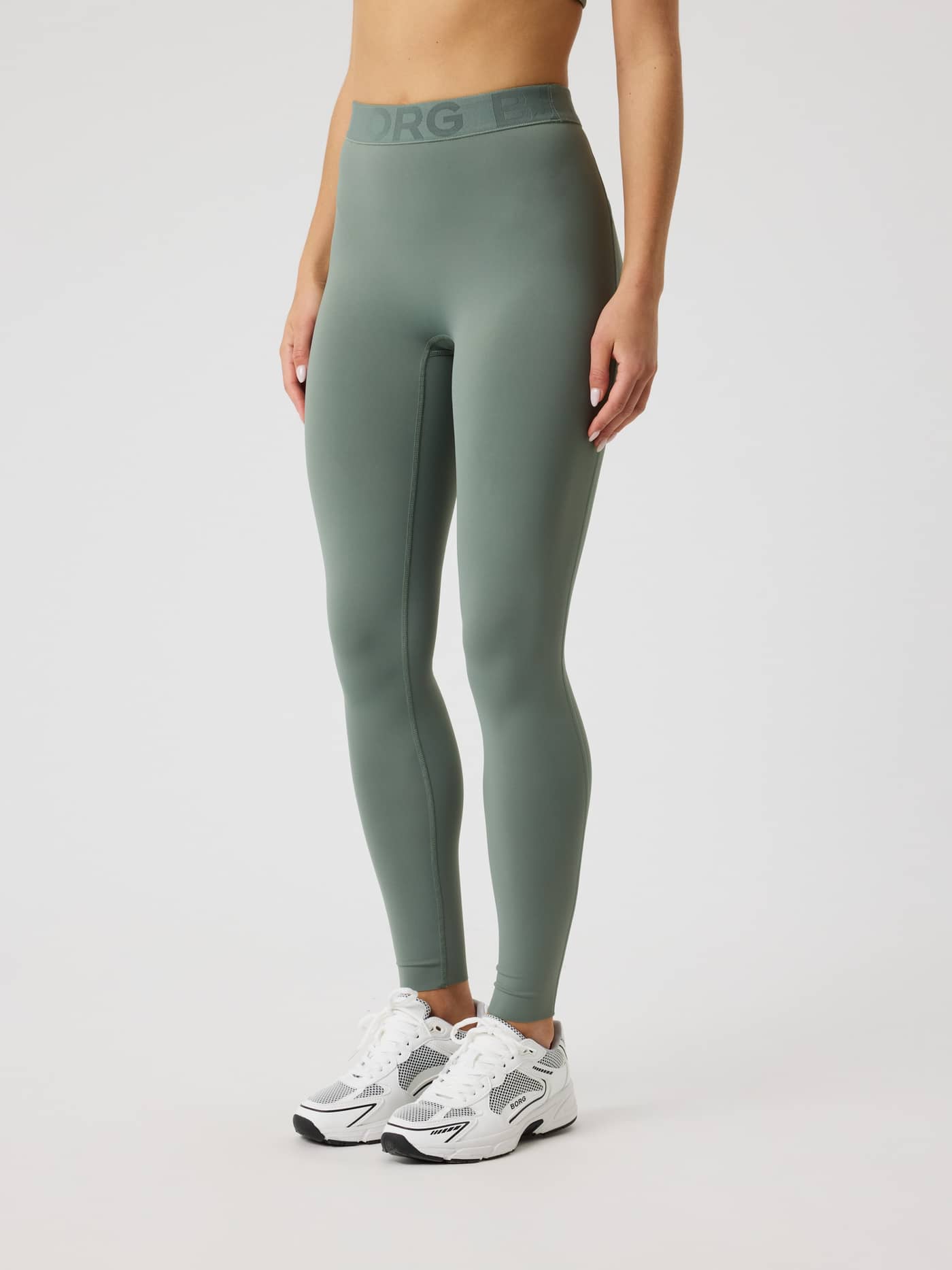 Front view of a model wearing the slim-fit Borg Tights in Agave Green (Green) for women's training. - Image 2