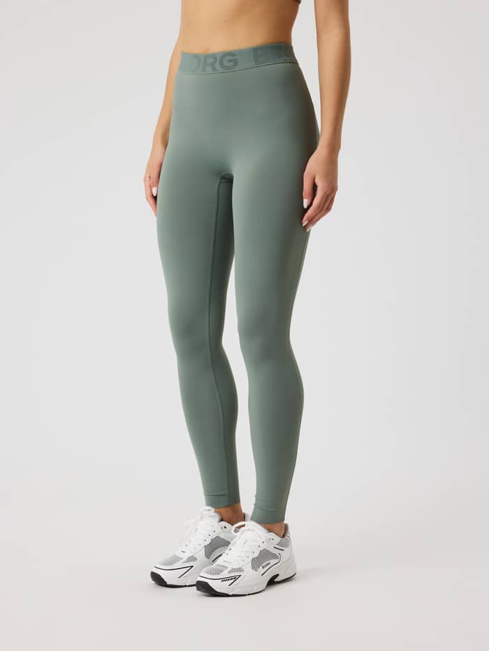 Front view of a model wearing the slim-fit Borg Tights in Agave Green (Green) for women's training. - Image 2