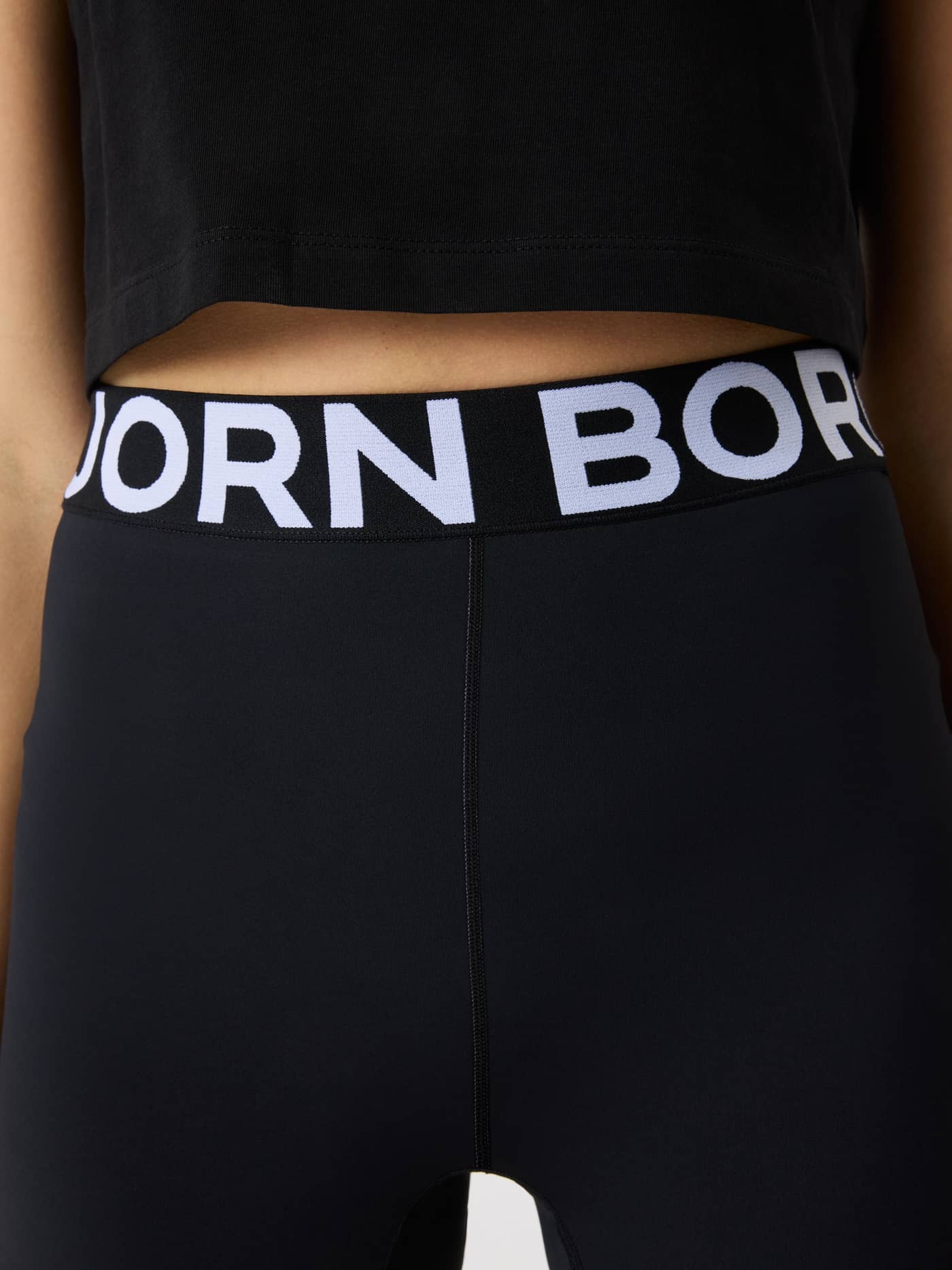 Close-up of the kids' training Björn Borg Short Tights in Black Beauty (Black), highlighting the white logo on the waistband. - Image 5