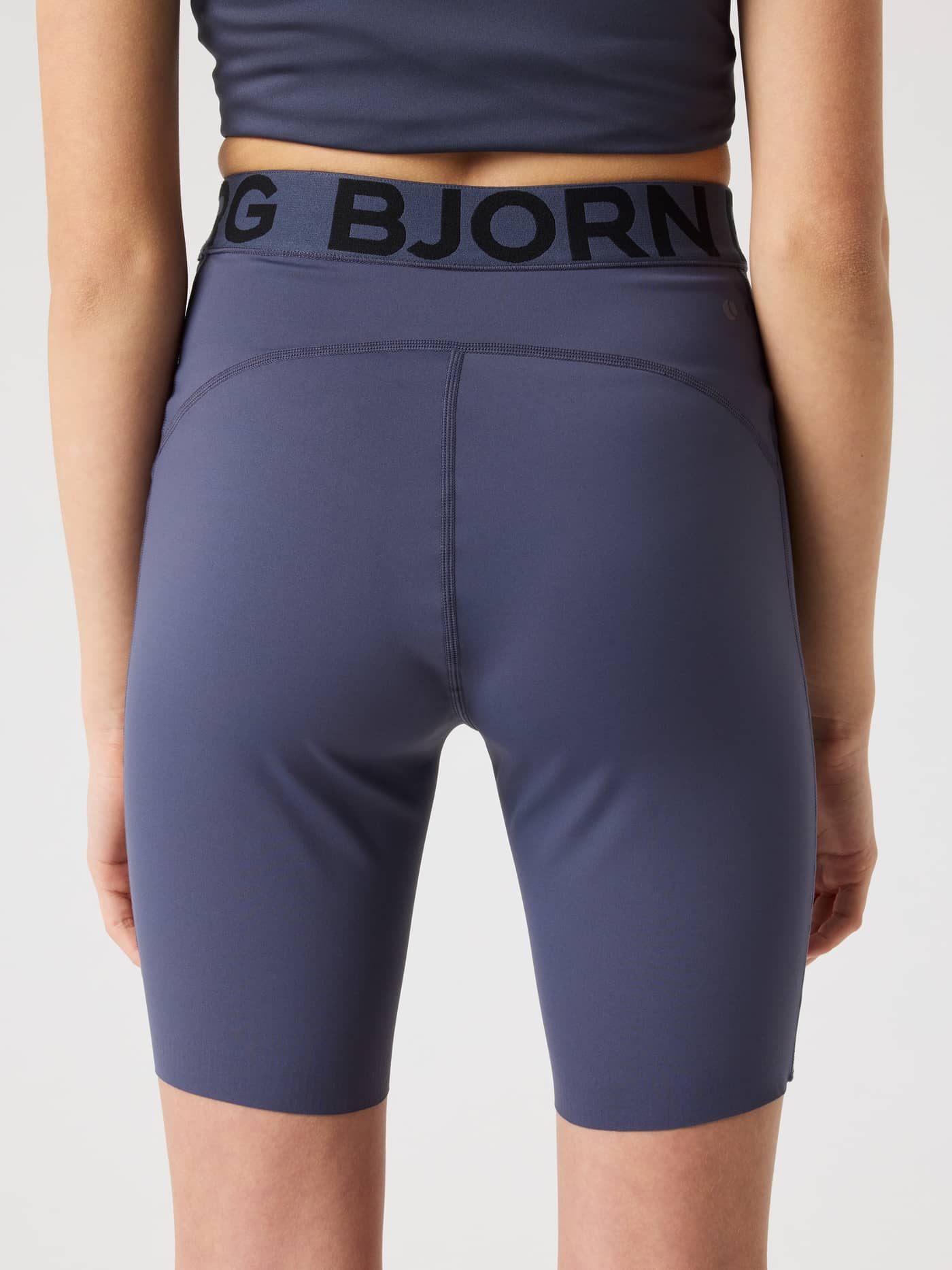 Back view of kids wearing the Odyssey Gray (Navy) Borg Short Tights for training with a black logo waistband. - Image 2