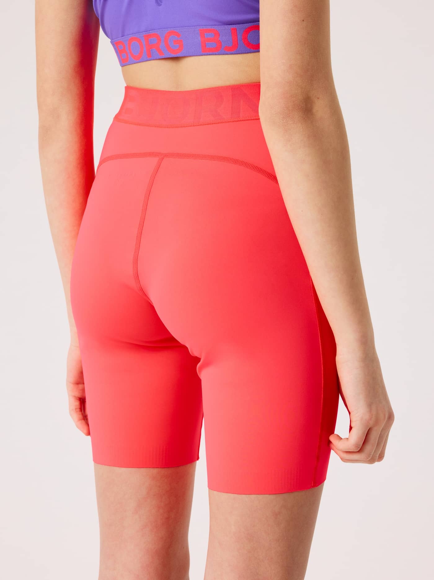 Back view of a model wearing kids' stretchy Björn Borg Short Tights in Diva Pink (Pink) for training. - Image 2