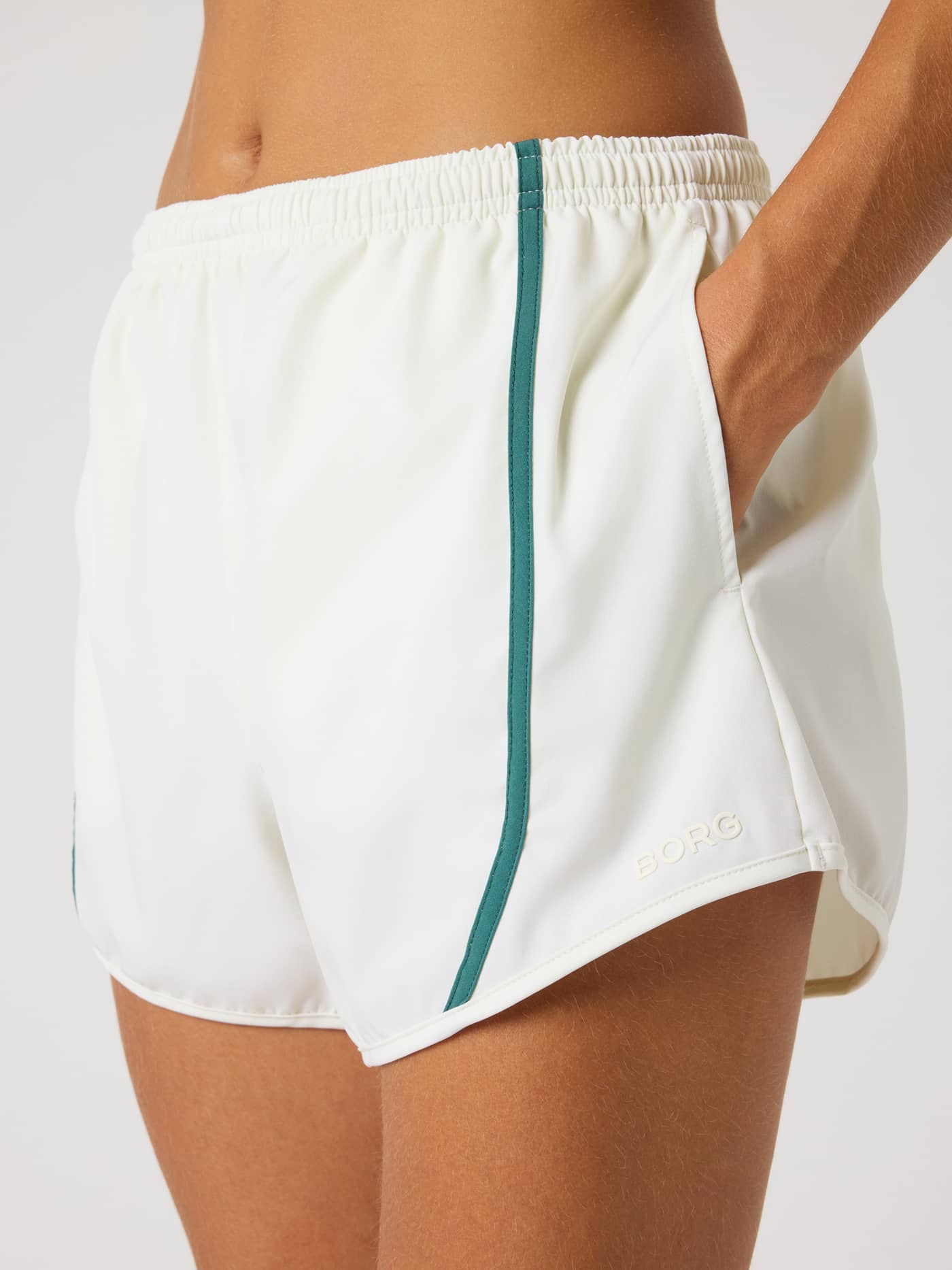 Detailed close-up of the stylish training Björn Borg Sports Shorts in Tofu (White) with green binding and a Tofu logo. - Image 4
