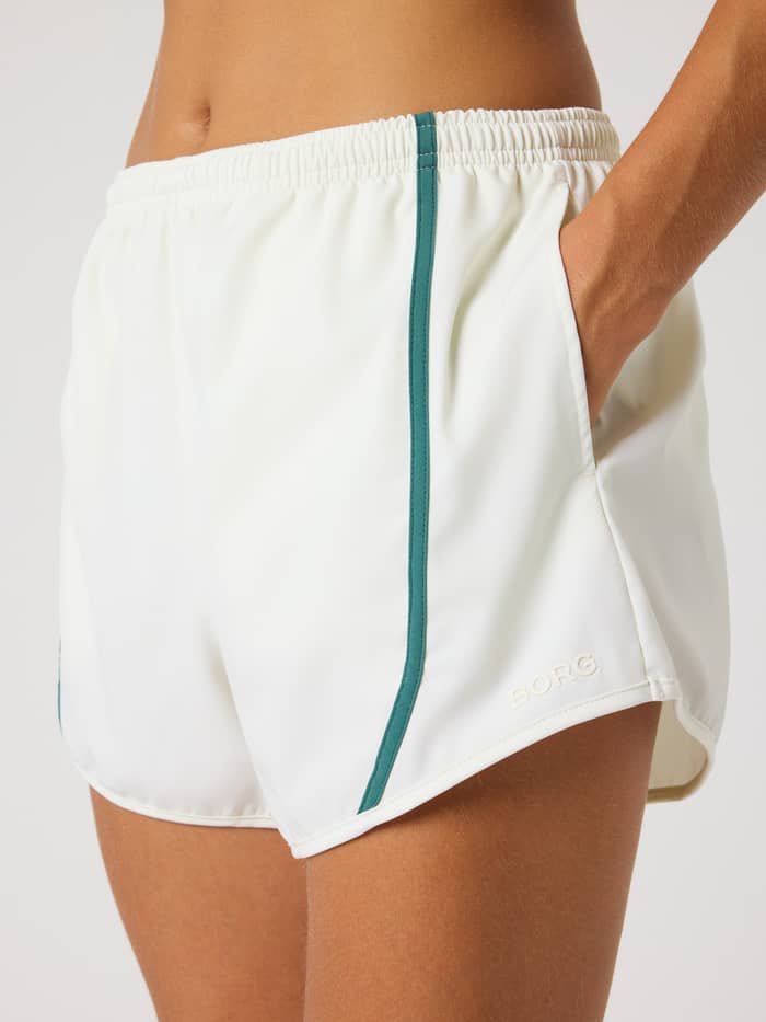 Detailed close-up of the stylish training Björn Borg Sports Shorts in Tofu (White) with green binding and a Tofu logo. - Image 4