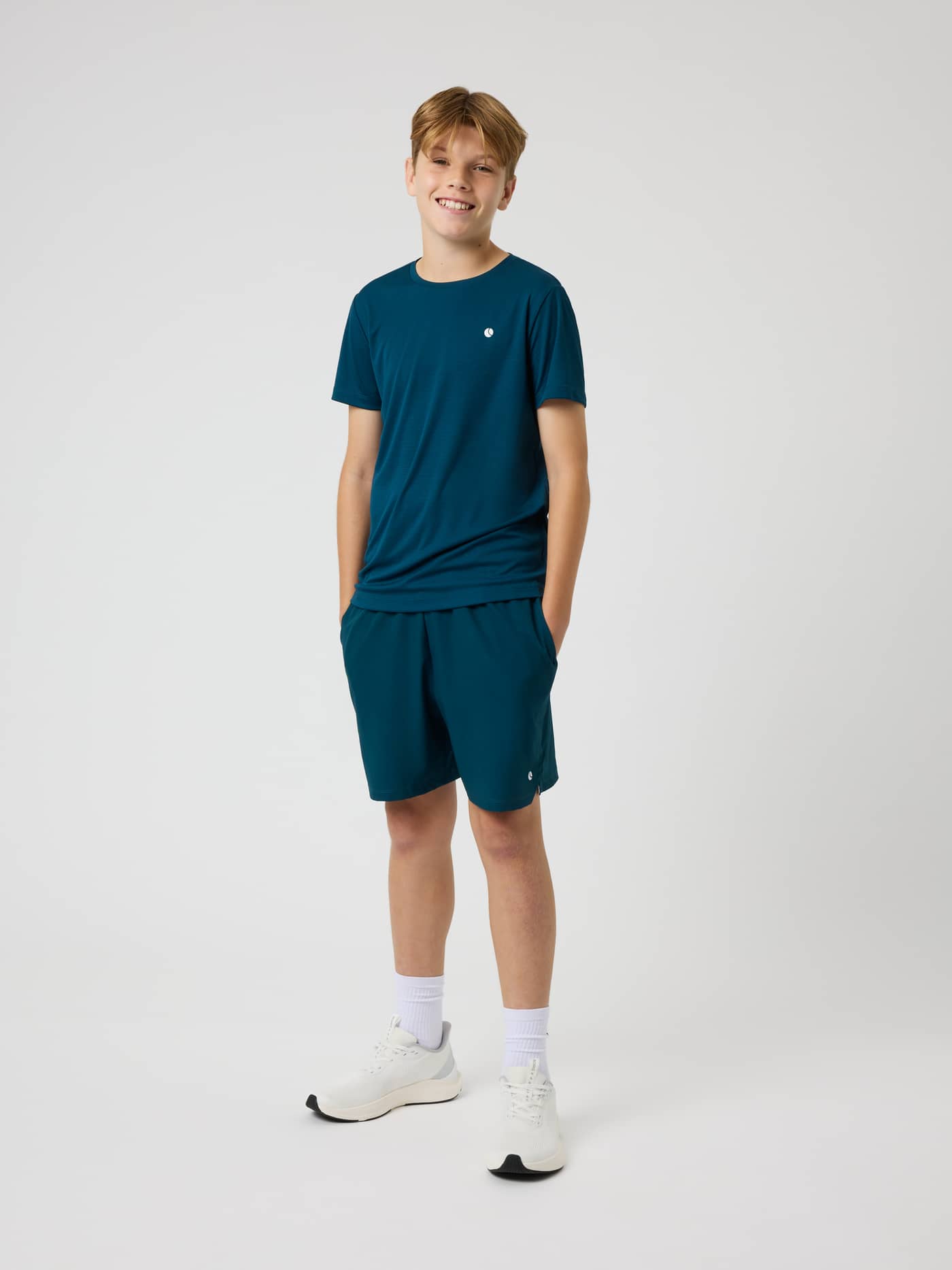 Front view of a kid in the Ace Light T-Shirt in Reflecting Pond (Green), a breathable performance top for tennis. - Image 3