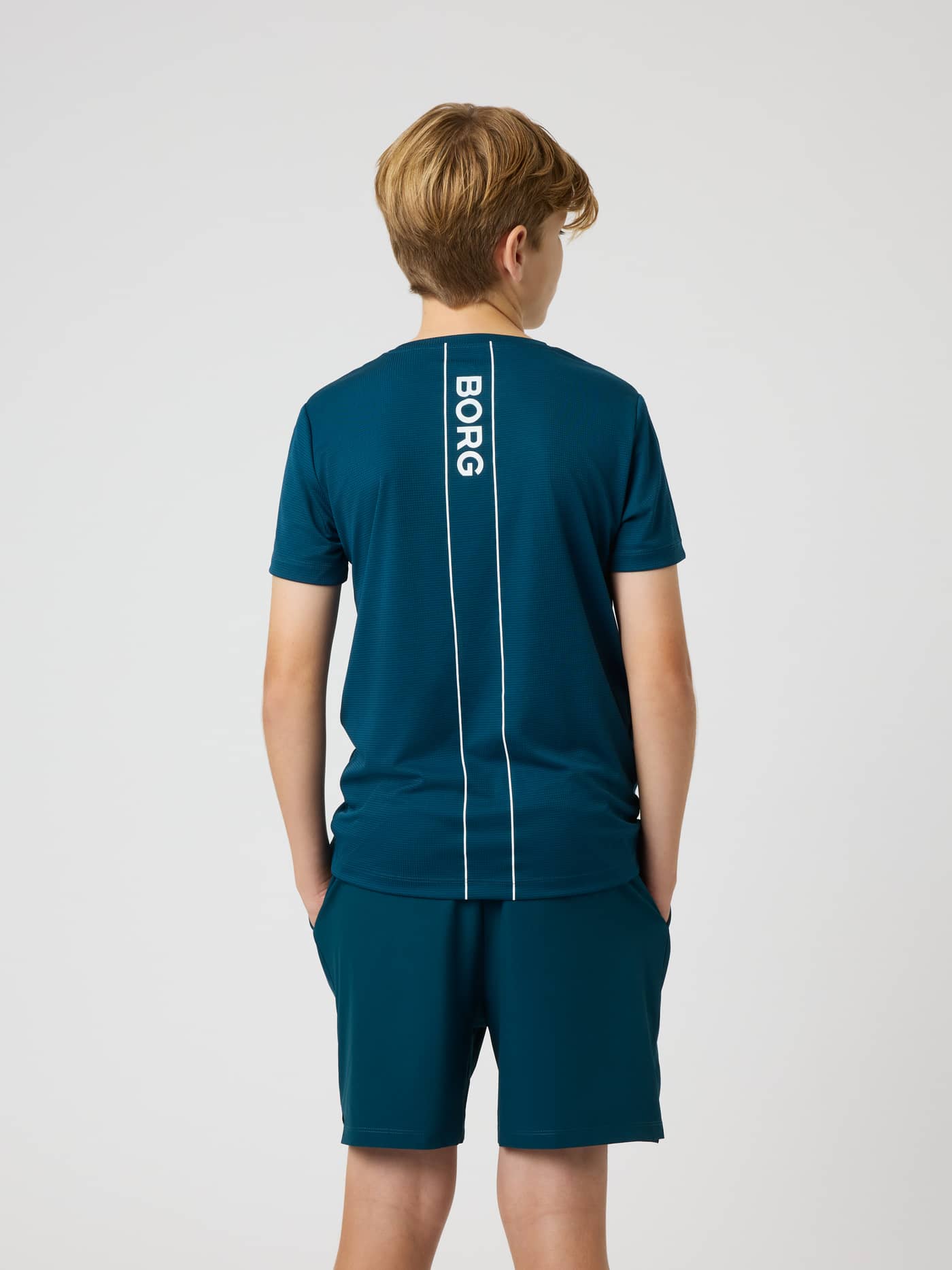 Back view of the kids Ace Light T-Shirt in Reflecting Pond (Green), featuring a vertical Borg logo for tennis. - Image 2