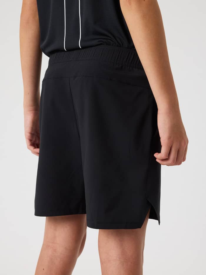 Back view of a model wearing black Björn Borg Ace Racquet Shorts for kids, featuring side slits for tennis performance. - Image 2