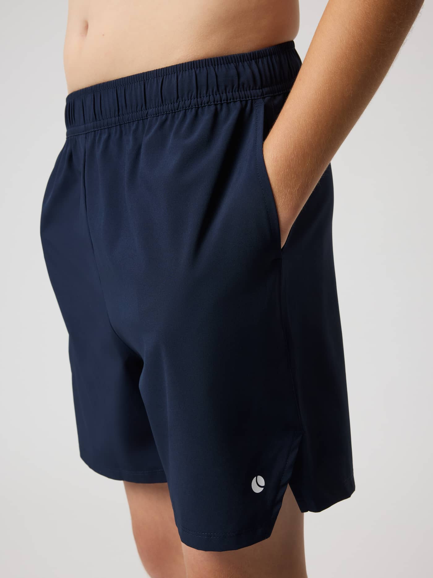 Side view of kids' Ace Racquet Shorts in Night Sky (Navy) featuring functional side slits and pockets for tennis. - Image 4