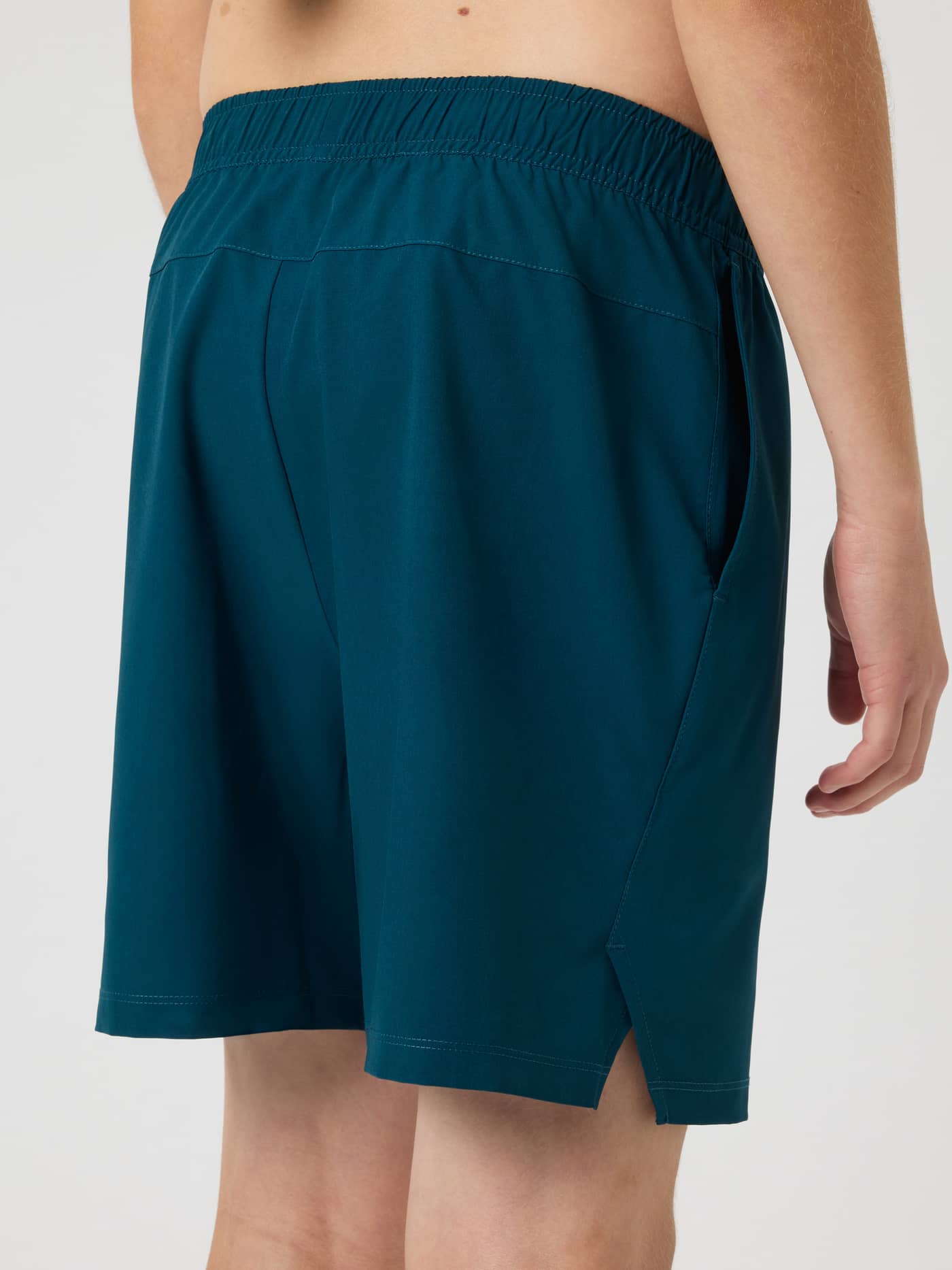 Björn Borg Ace Racquet Shorts in Reflecting Pond (Green) for kids' tennis, shown from the back with side slits. - Image 3
