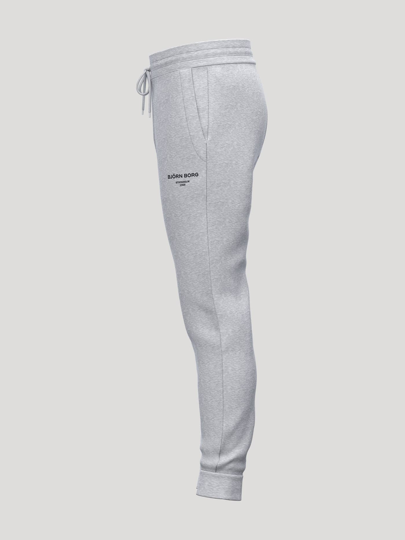 Side view of Borg Essential 1 Tapered Sweatpants in Light Grey Melange (Grey) with a black logo for tennis style. - Image 3