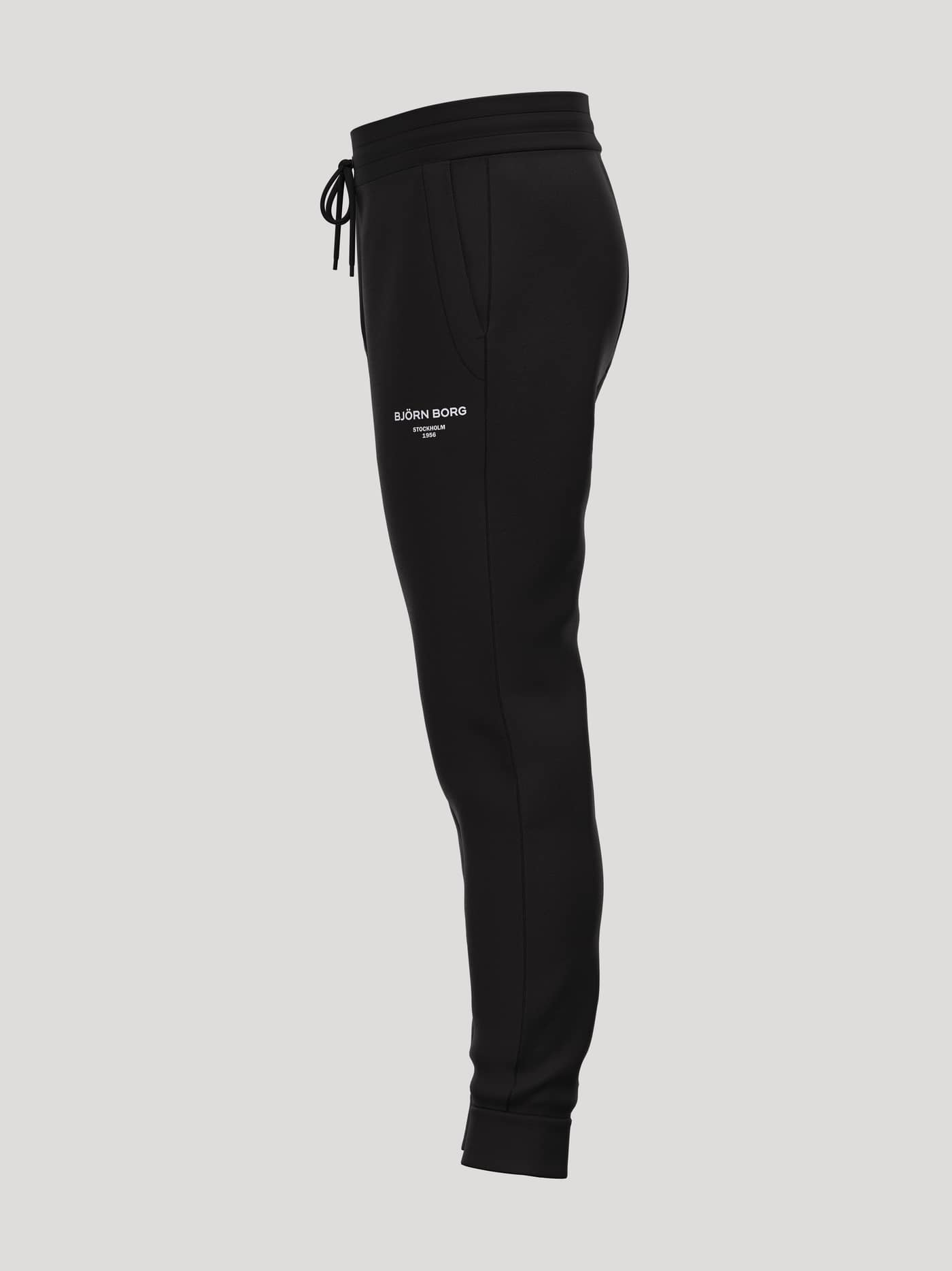 Side view of Borg Essential 1 Tapered Sweatpants in Black Beauty (Black) featuring a white logo and tapered fit. - Image 3