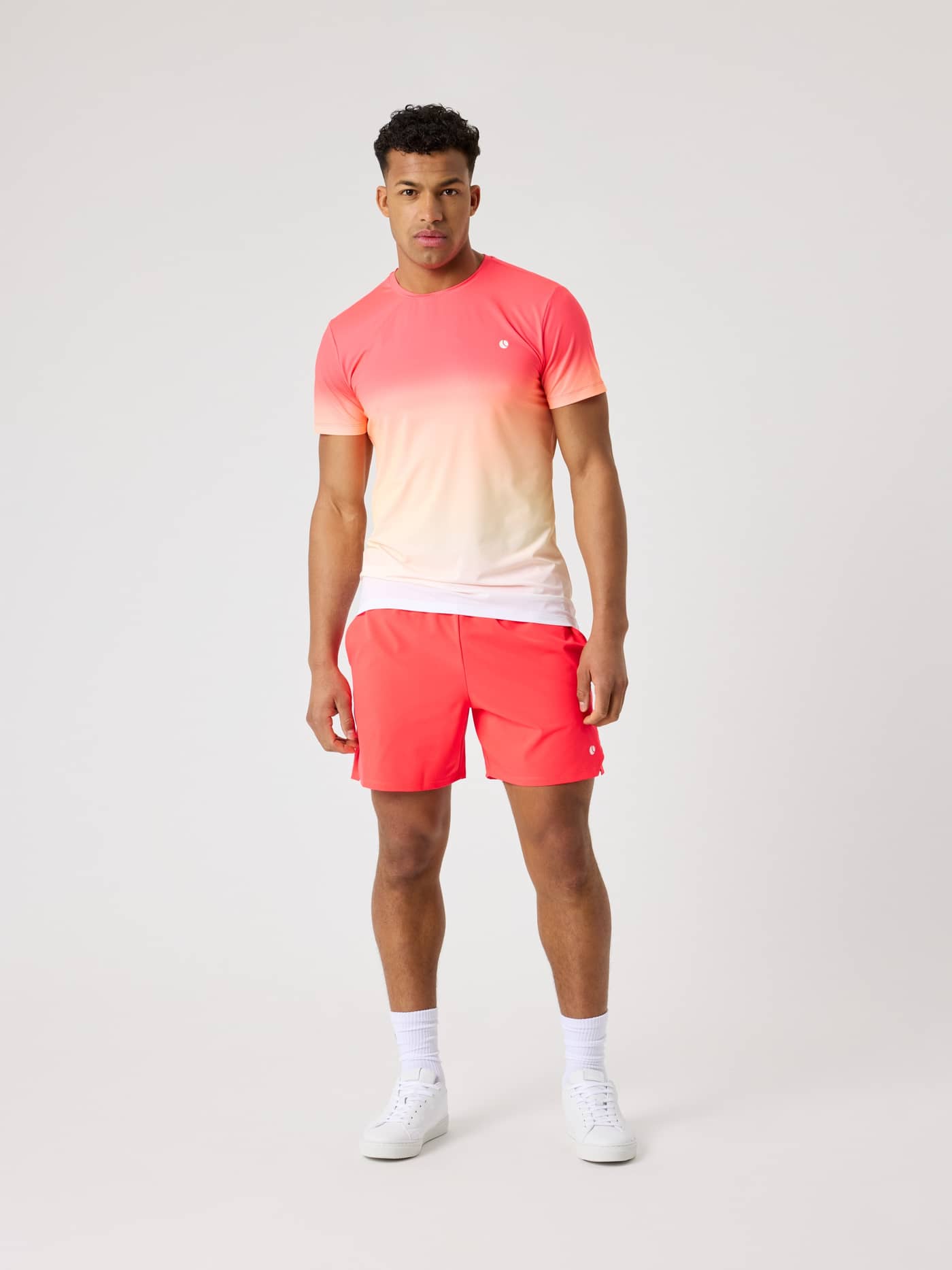 Full-body front view of a man in the Björn Borg Ace Printed T-Shirt in Fading 1 (Pink, White) for performance tennis. - Image 3