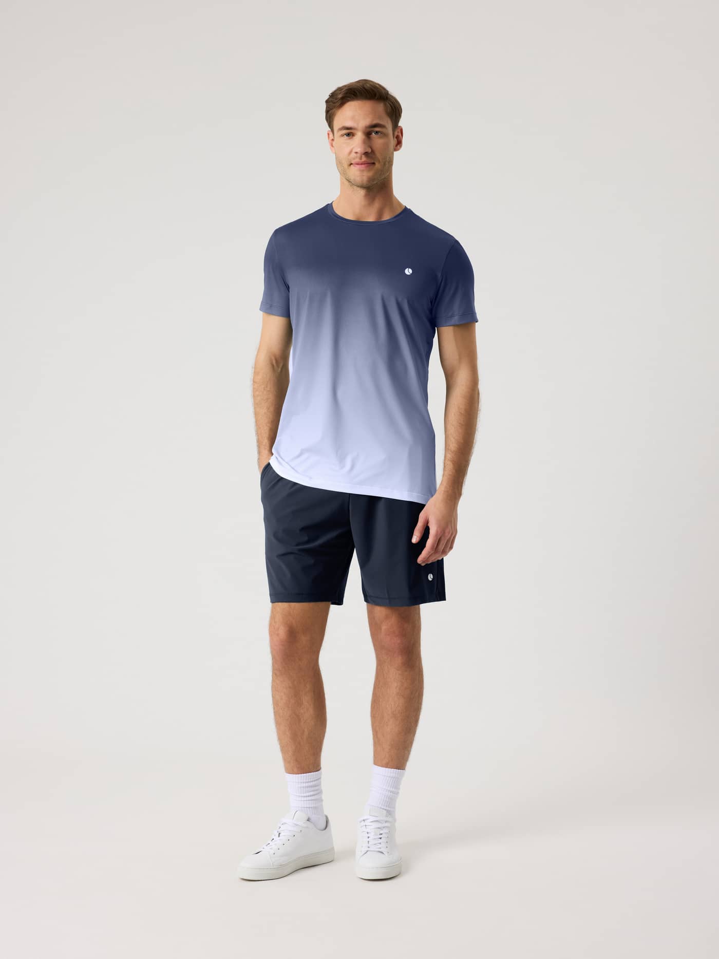 Full-body front view of a man wearing the Björn Borg Ace Printed T-Shirt in Fading 4 (Navy and White) for tennis. - Image 3