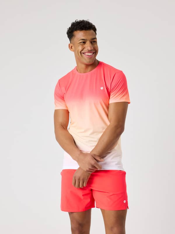 Front view of a man wearing the Björn Borg Ace Printed T-Shirt in Fading 1 (Pink, White) for performance tennis.